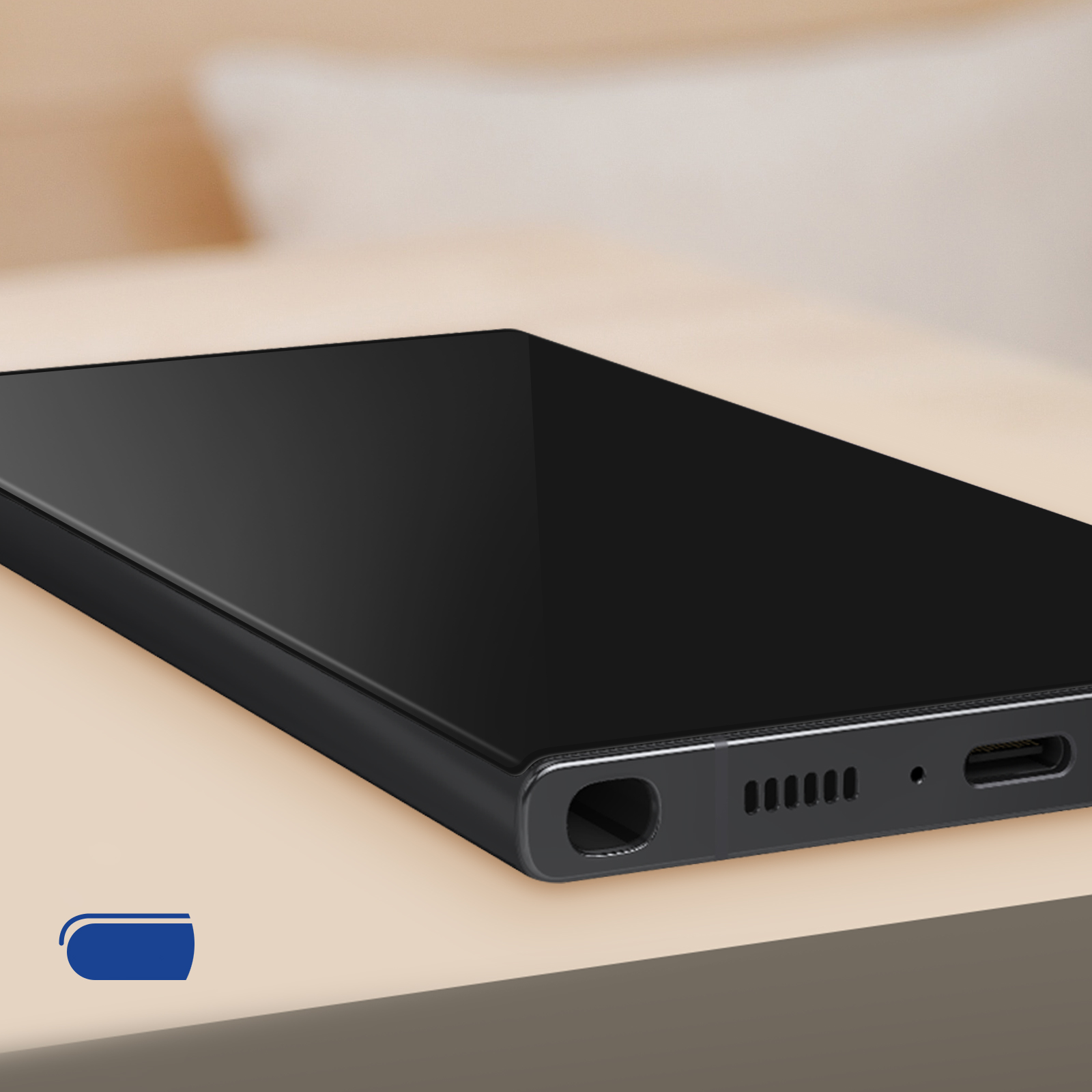 Telefon z czarnym ekranem. Telefon leży na stole i ma czarną ramkę.