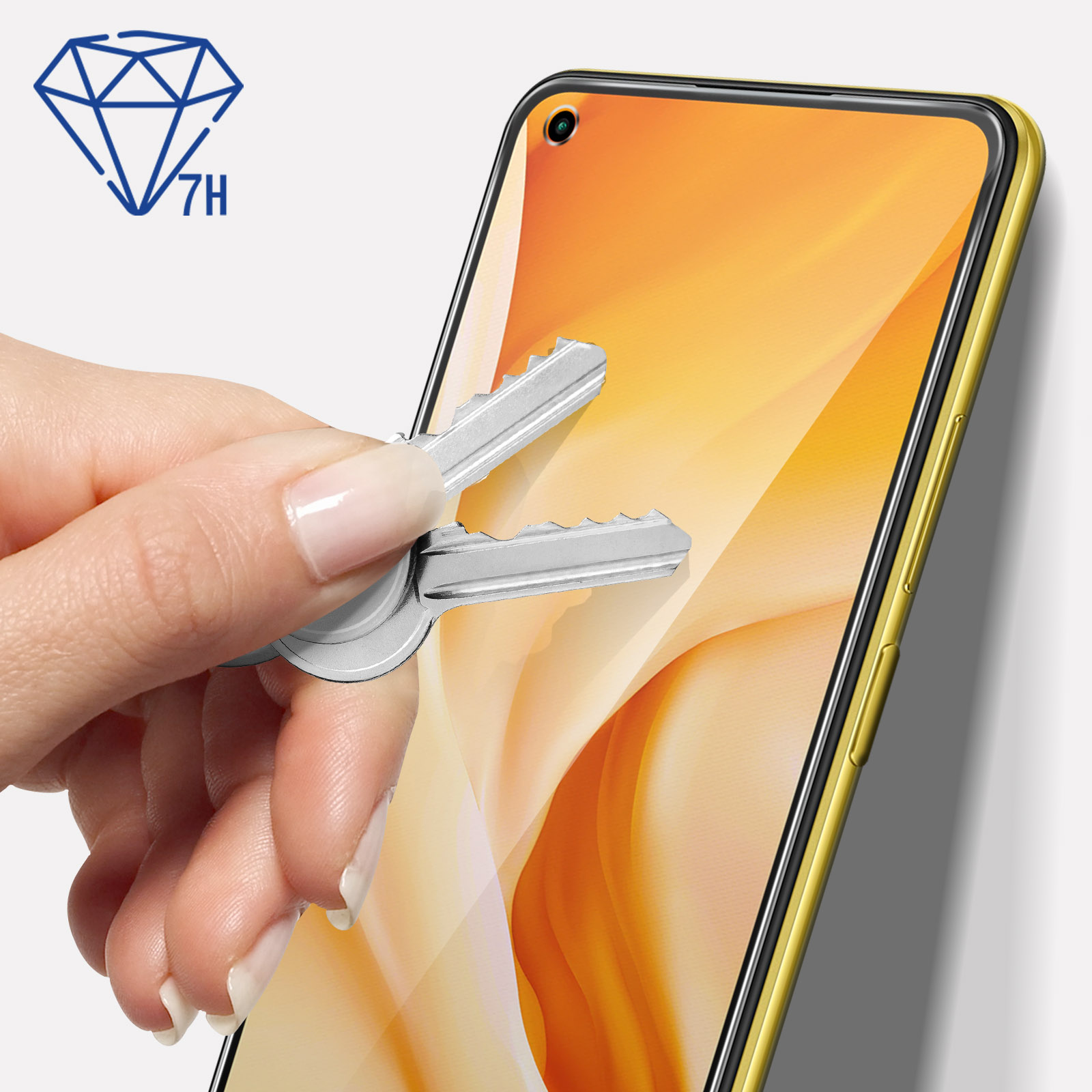 Ręka trzymająca klucze obok telefonu. Symbol diamentu i 7H w rogu. Telefon ma żółtą ramkę.