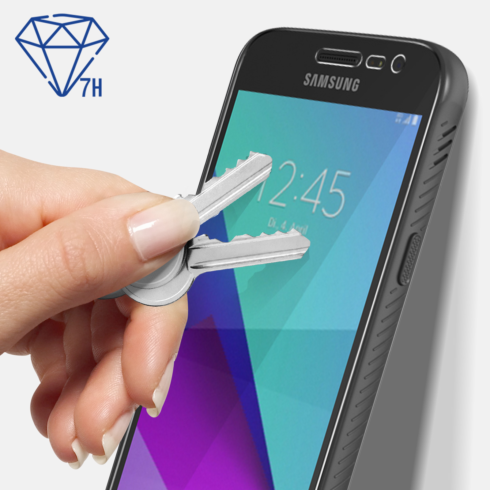 Una mano che tiene delle chiavi vicino a un telefono con una protezione schermo. Simbolo diamante e 7H nell'angolo.
