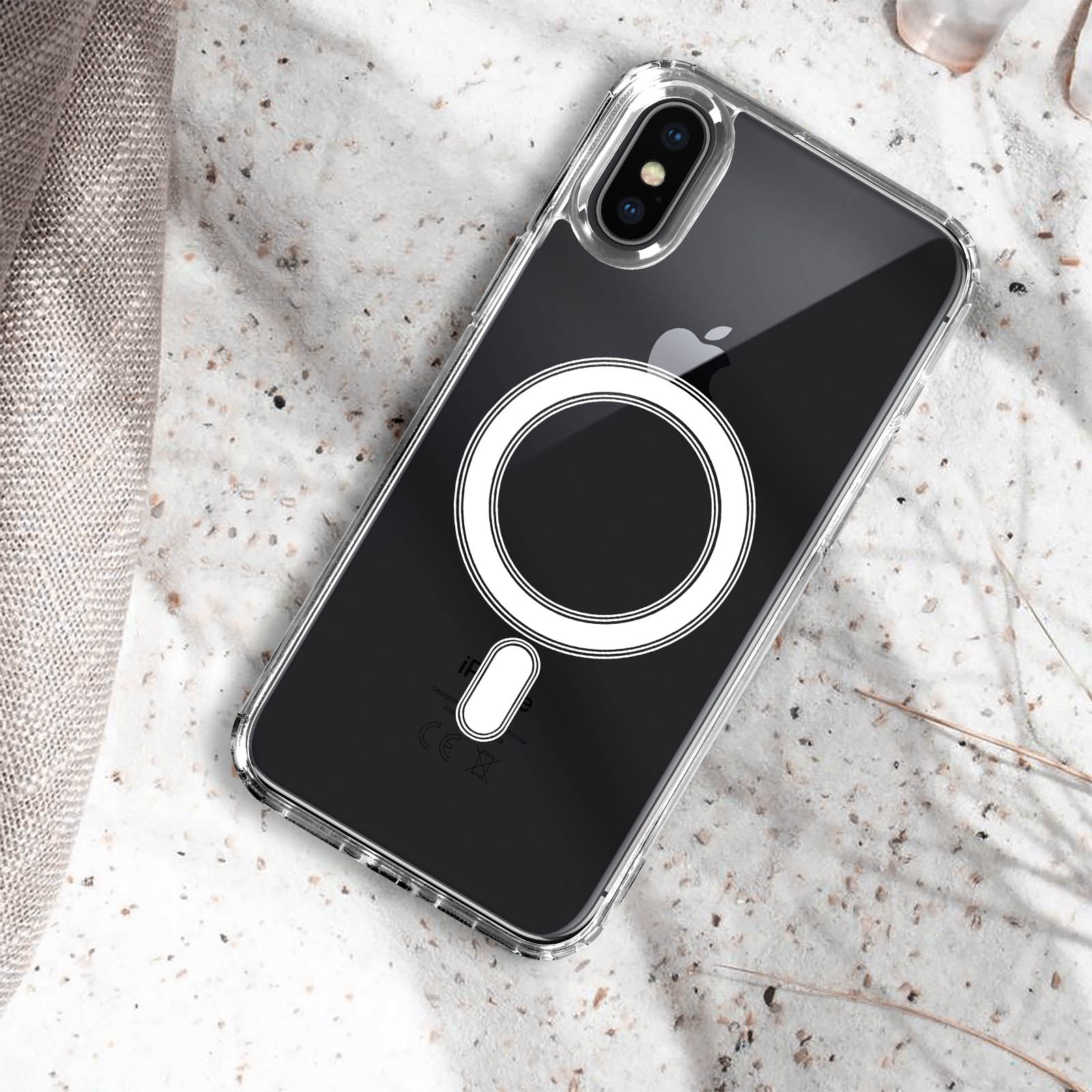 Custodia trasparente per telefono su una superficie, con logo Apple e cerchio bianco con anello.