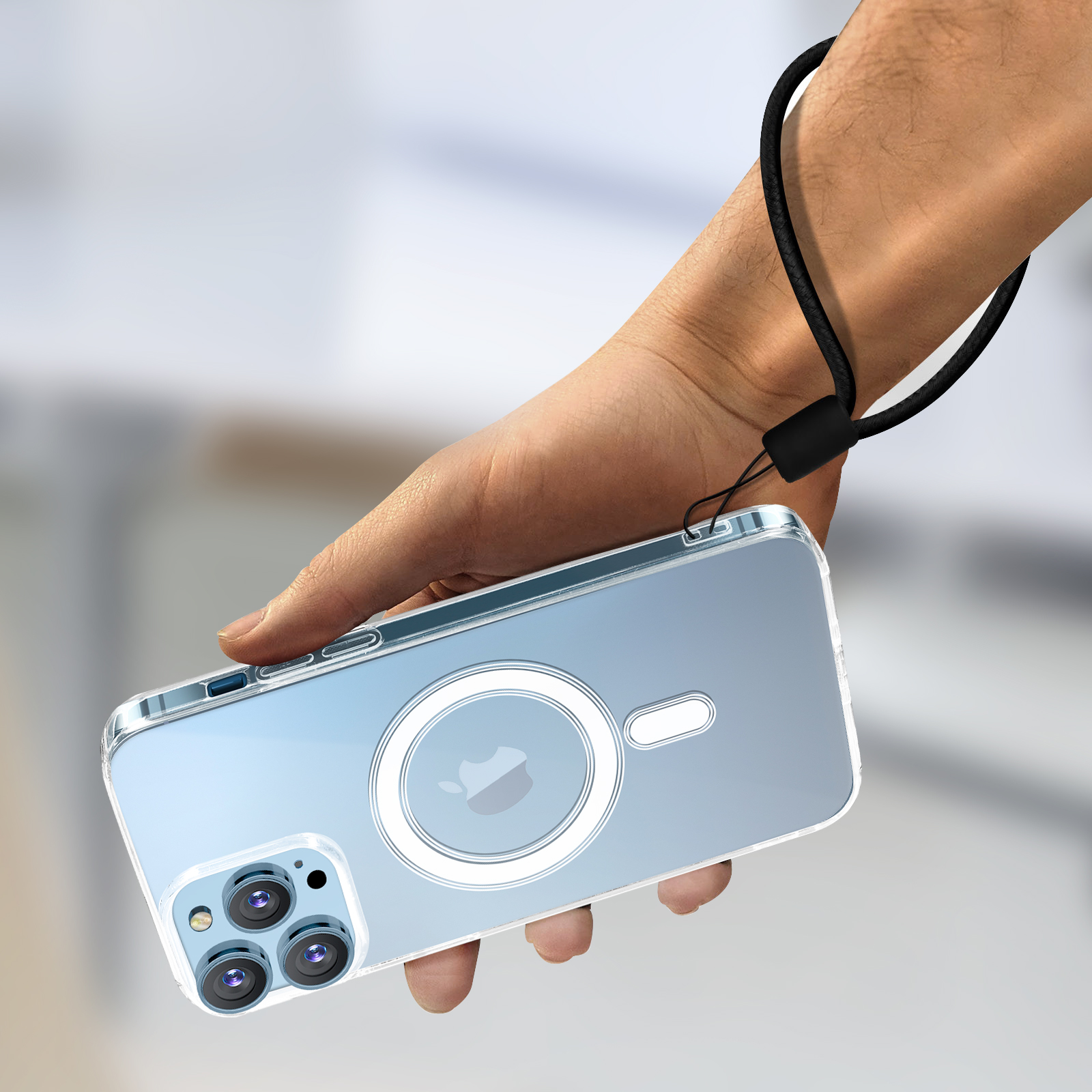Hand die een doorzichtige telefoonhoes vasthoudt met een zwart koord. Telefoon heeft een wit cirkelontwerp.