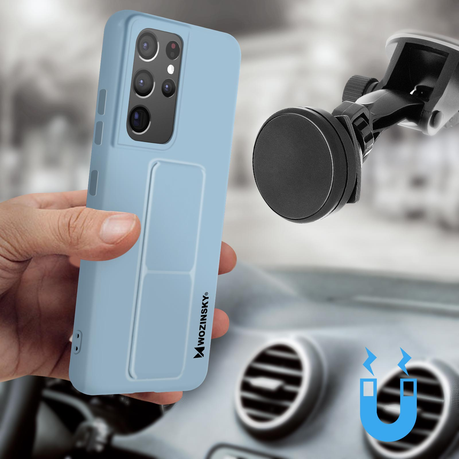 Jasnoniebieskie etui na telefon z dołączonym uchwytem magnetycznym, trzymane w dłoni. Widoczne wnętrze samochodu.