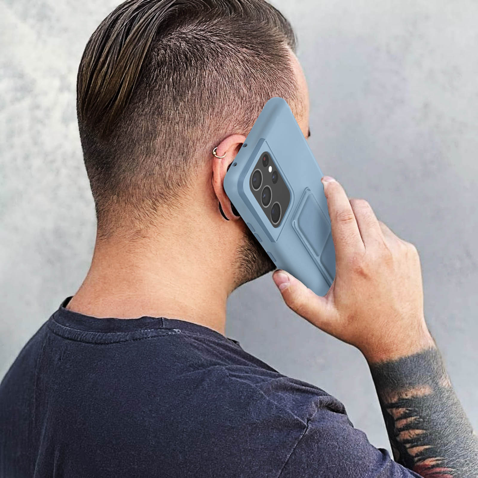 Mężczyzna trzymający niebieskie etui na telefon ze stojakiem, zbliżenie od tyłu.