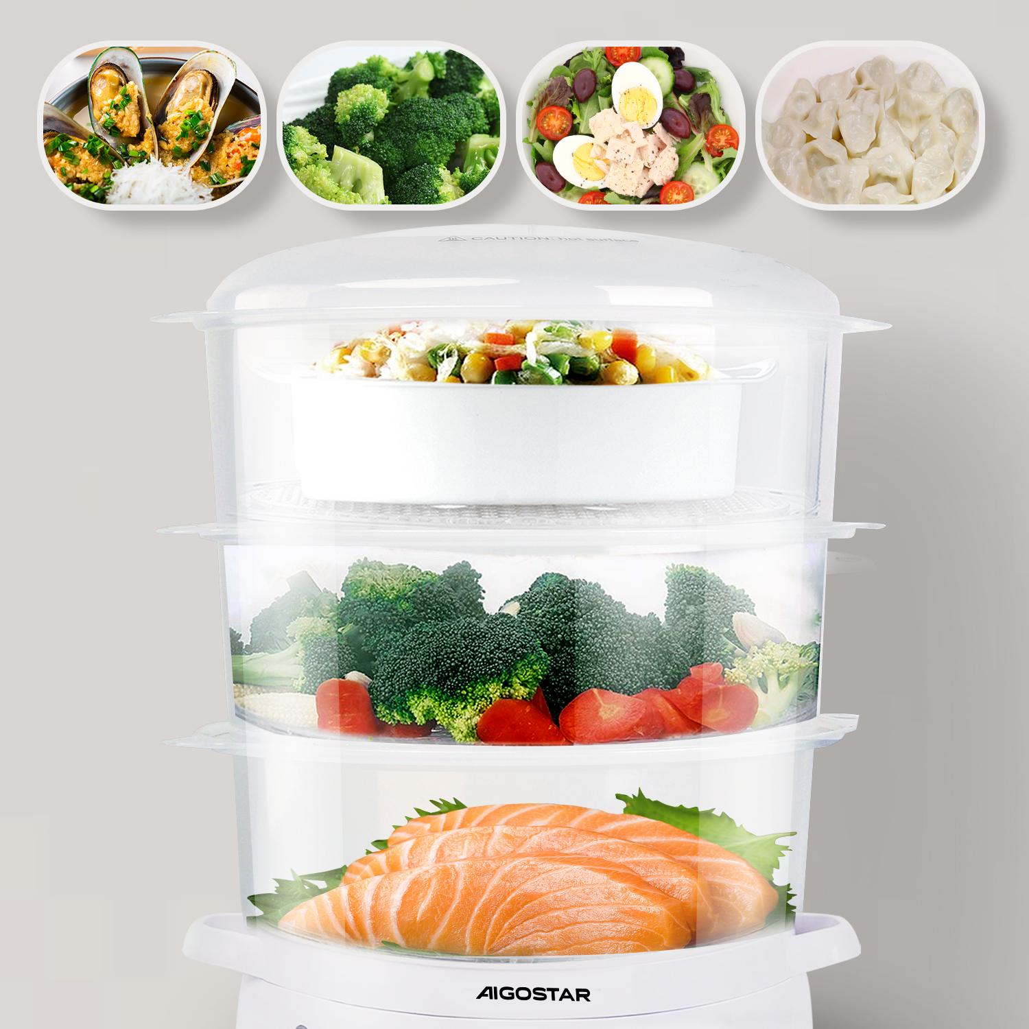 Ein mehrstöckiger Dampfgarer mit verschiedenen Lebensmitteln, darunter Lachs, Brokkoli und Salat.