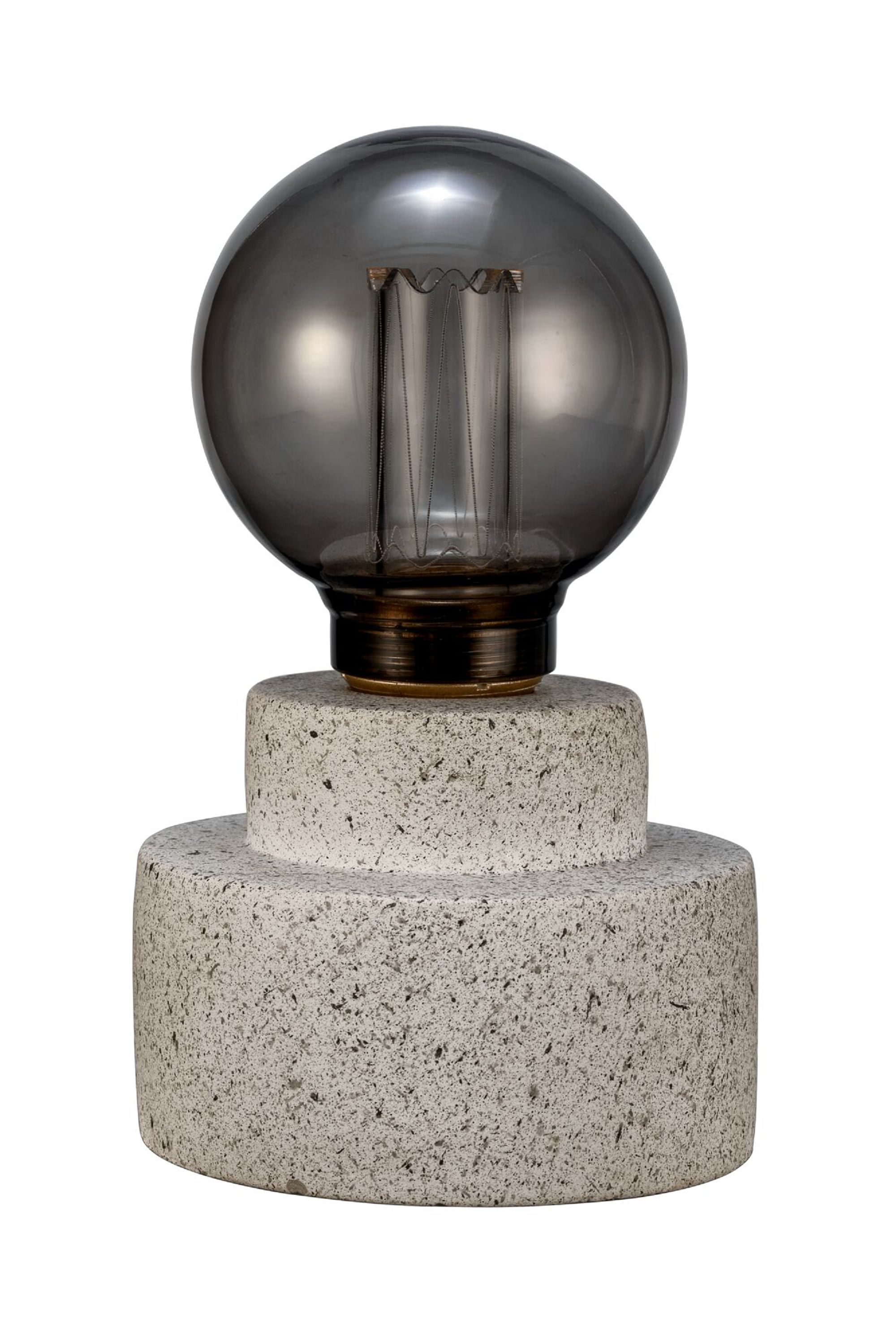 Nowoczesna lampa z szarą szklaną żarówką na teksturowanej kamiennej podstawie, na białym tle.