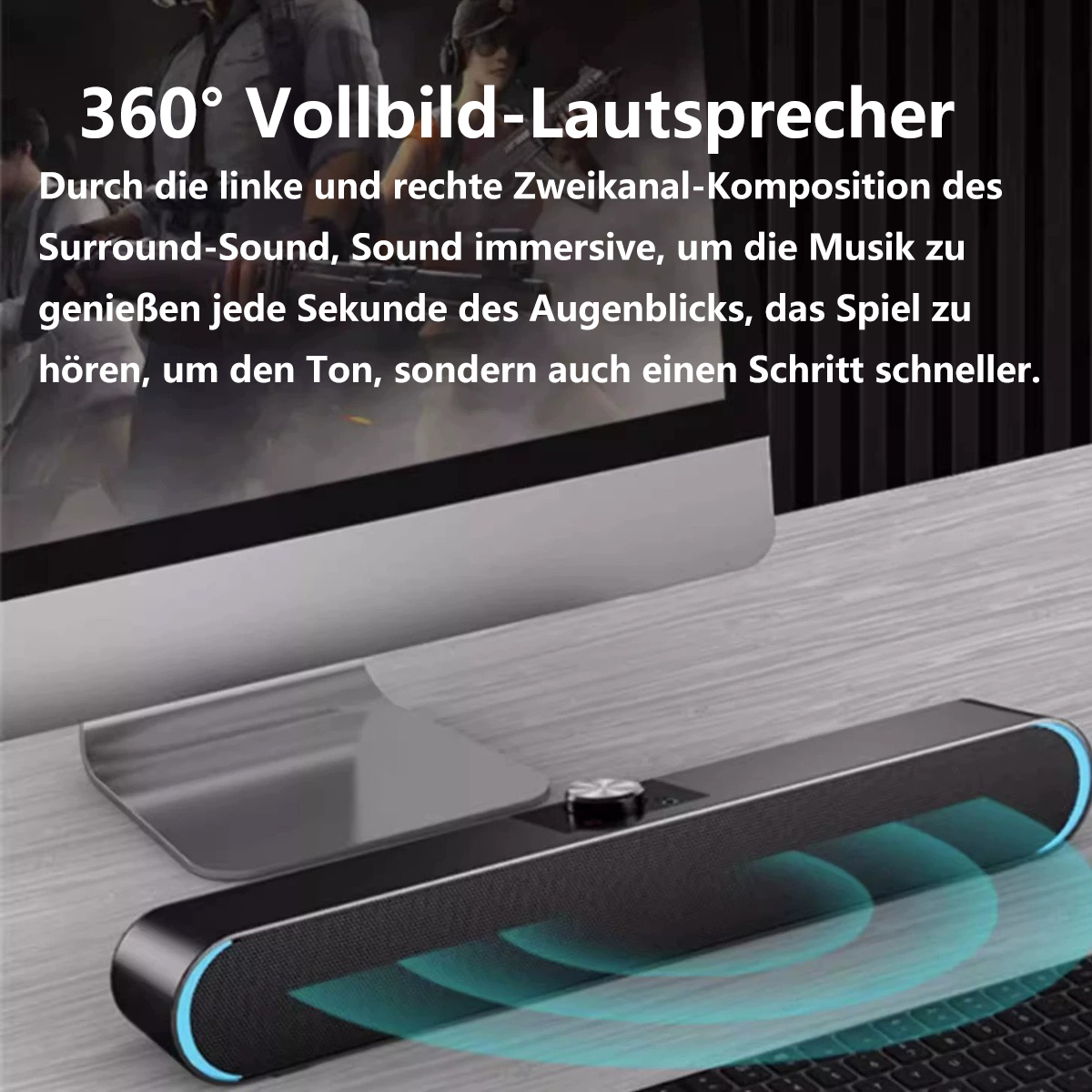 Eine schwarze Soundbar mit blauen Lichtern, im Hintergrund eine Tastatur und ein Monitor.