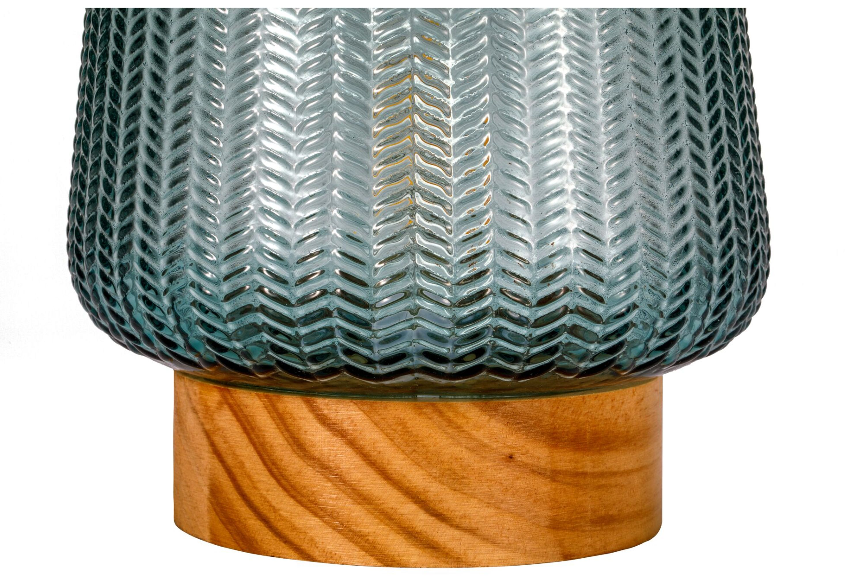 Zbliżenie szklanego wazonu z drewnianą podstawą. Wazon jest turkusowy i ma teksturowany wzór.