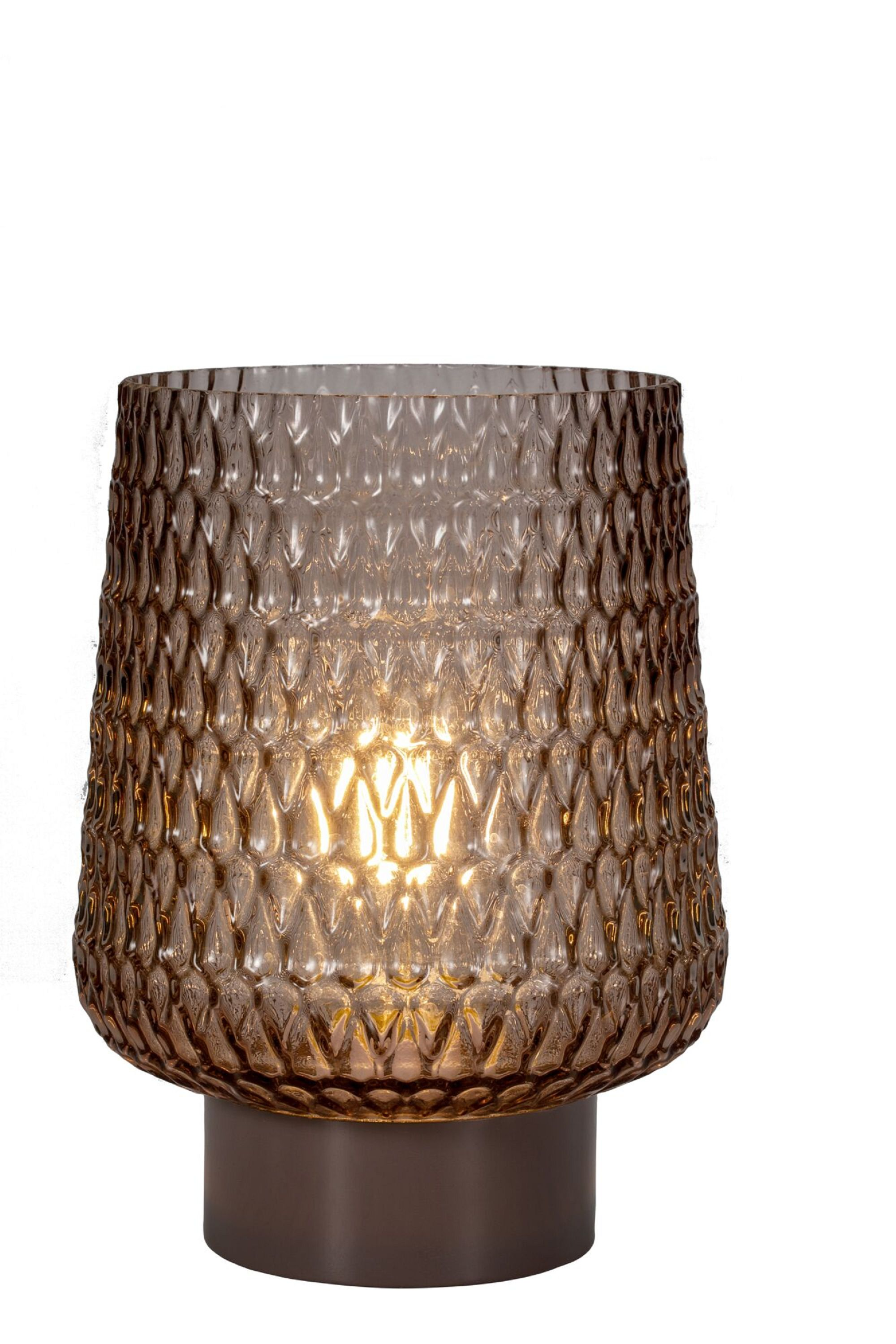 Lampa ze wzorzystym szkłem i światłem w środku, na białym tle.