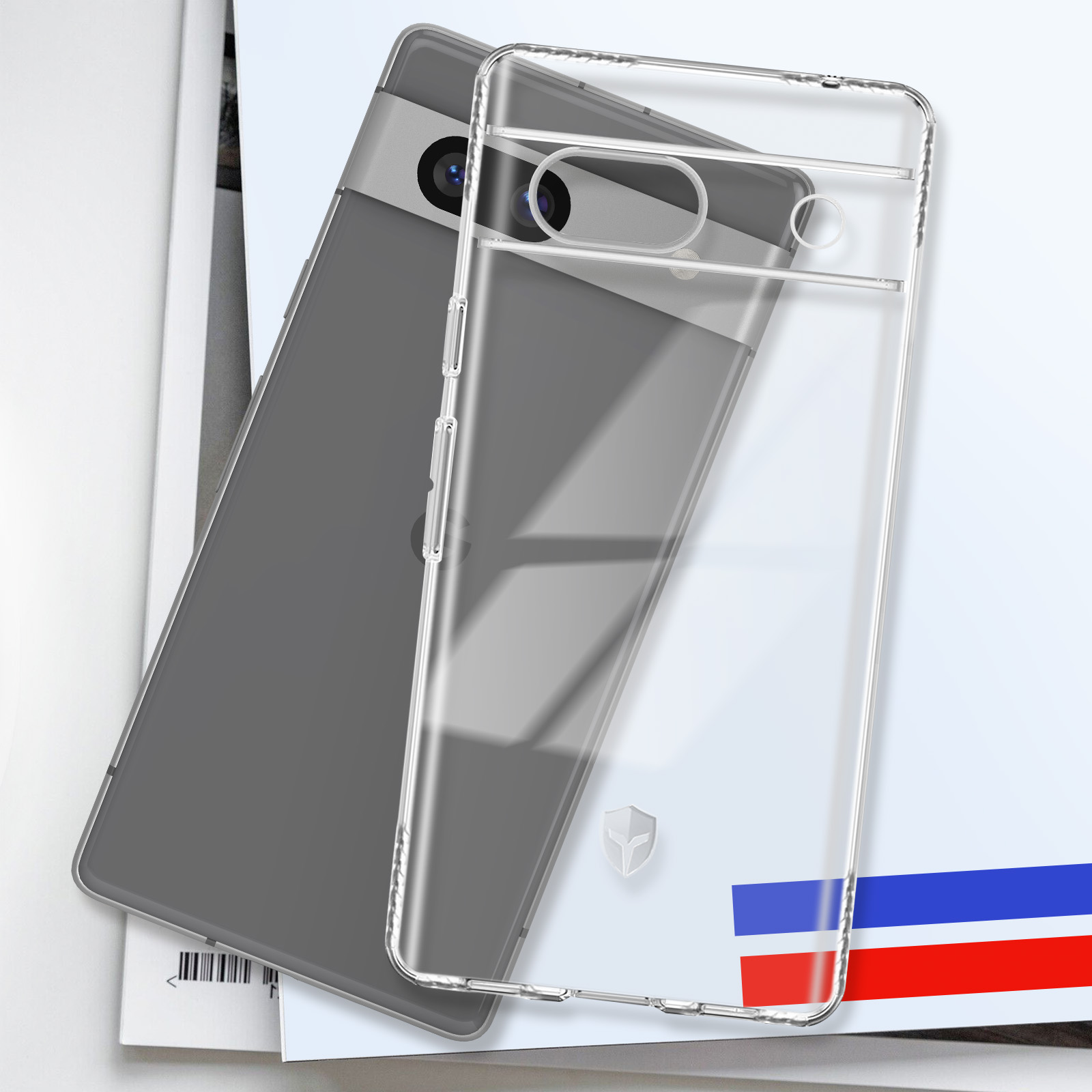Een telefoonhoesje en een telefoon. De hoes is doorzichtig en de telefoon grijs. Op een tijdschrift.