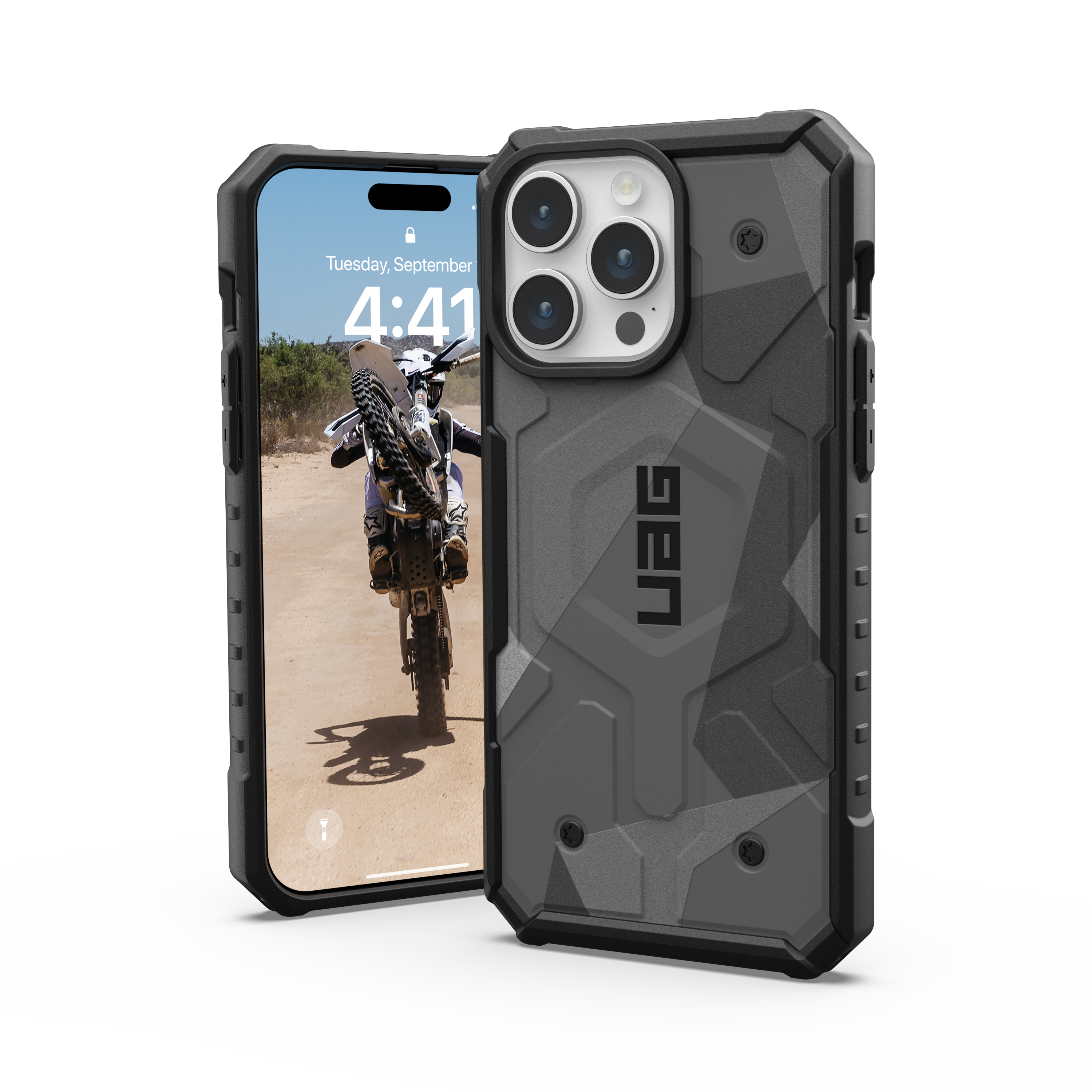 Telefon mit UAG-Hülle. Das Telefon zeigt einen Motocross-Fahrer. Die Hülle ist grau und schwarz.