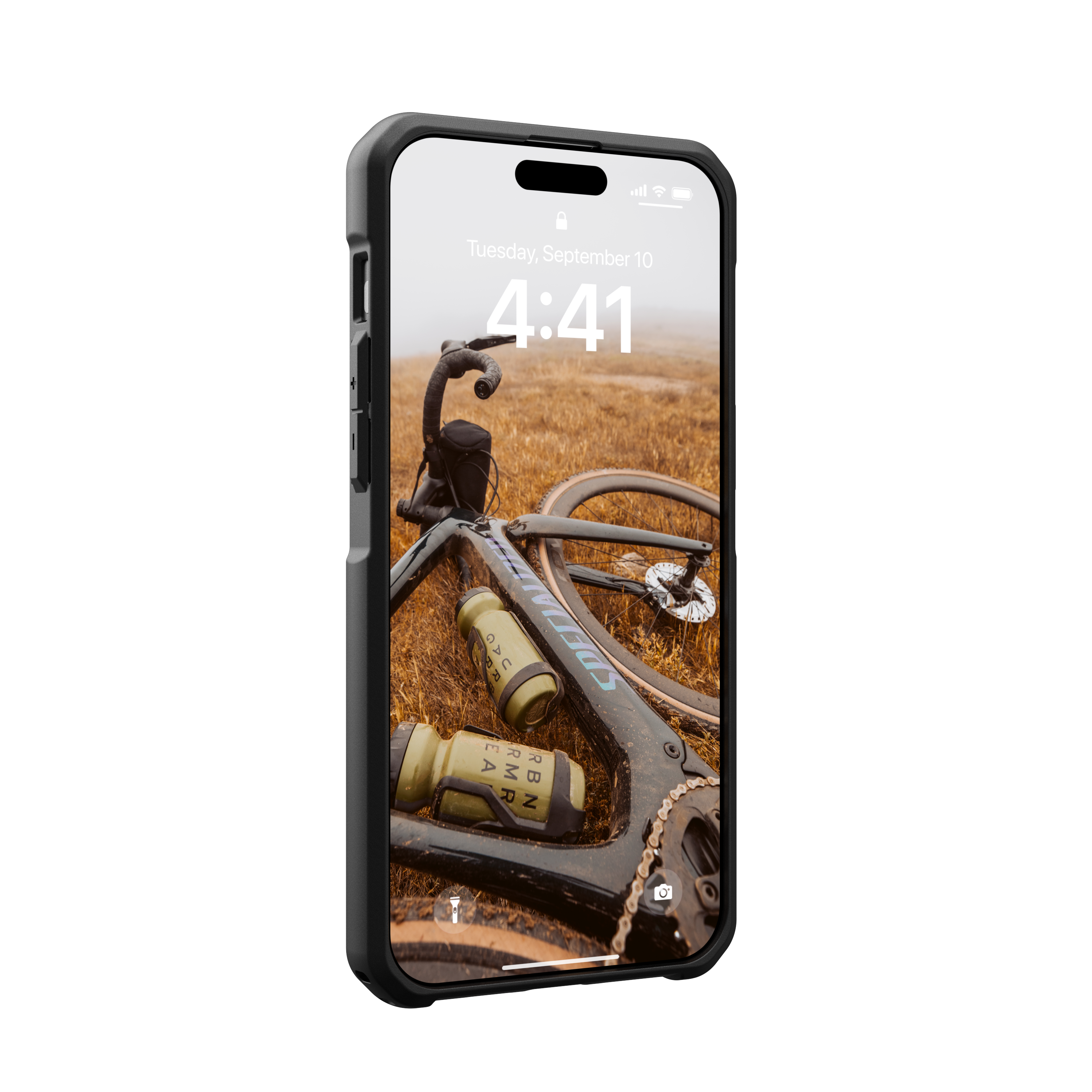 Smartphone in schwarzem Gehäuse, zeigt Fahrrad auf grasbewachsenem Feld. Das Fahrrad hat zwei grüne Wasserflaschen.