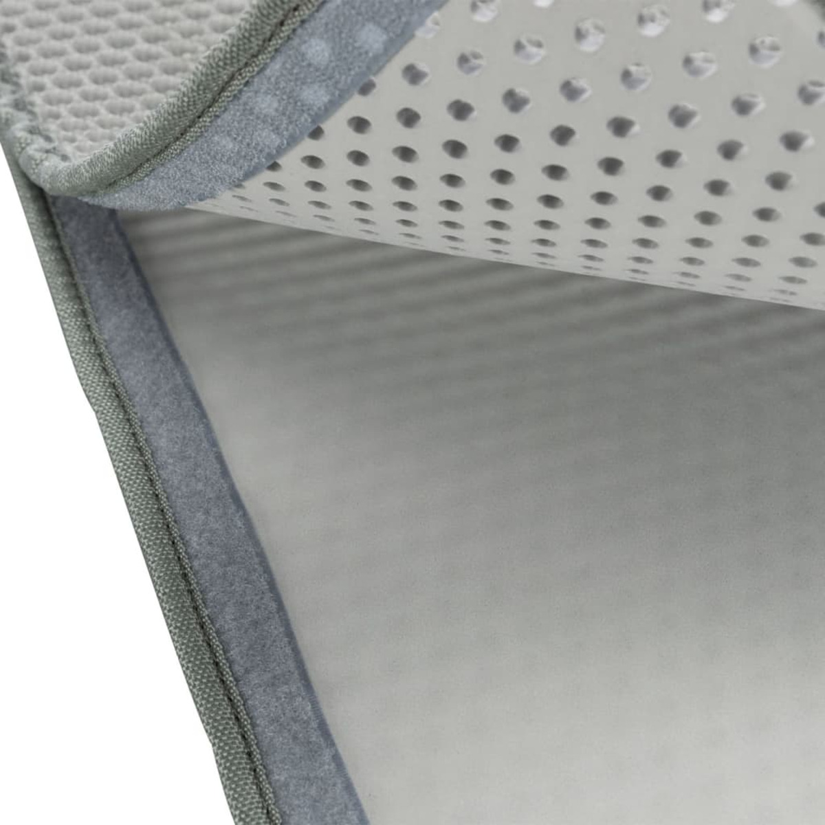 Primer plano de una almohadilla gris texturizada. Superficie con agujeros, borde gris.