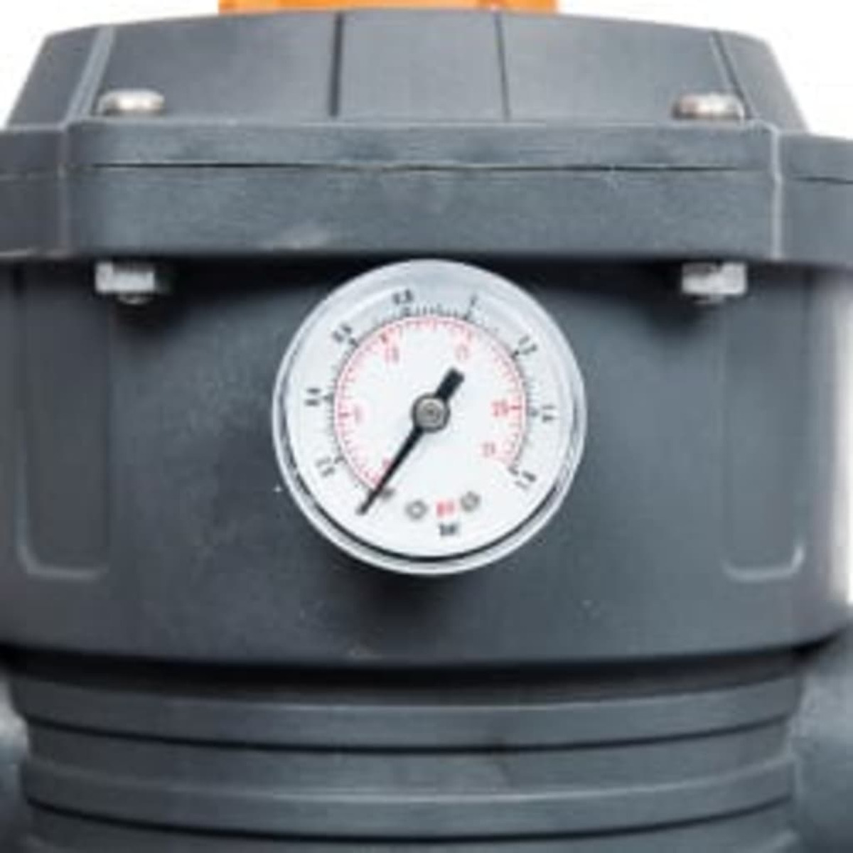 Close-up of a gauge on a grey machine. It has a white face.