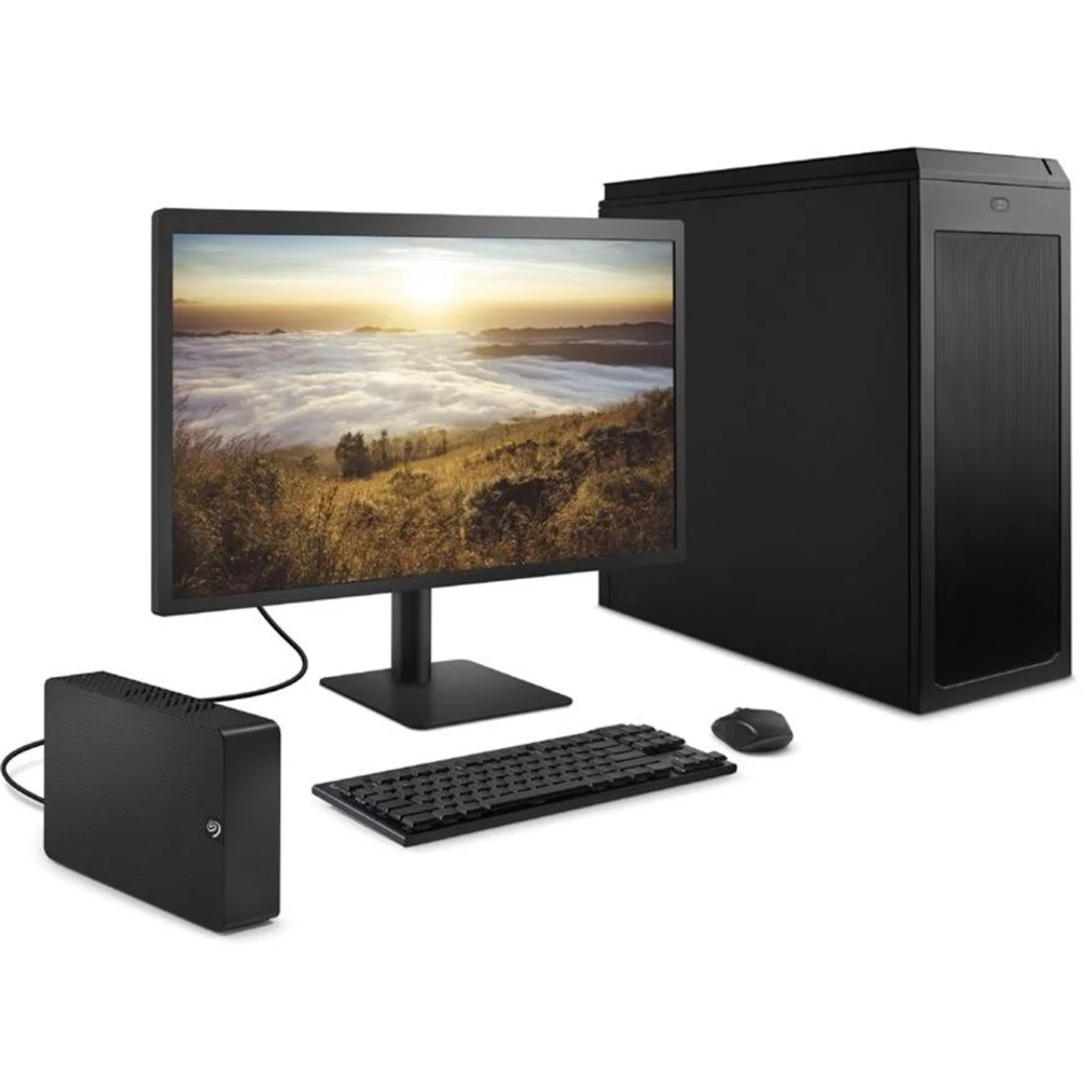 Une configuration d'ordinateur noire avec un écran affichant un coucher de soleil, un clavier, une souris et un boîtier noir.