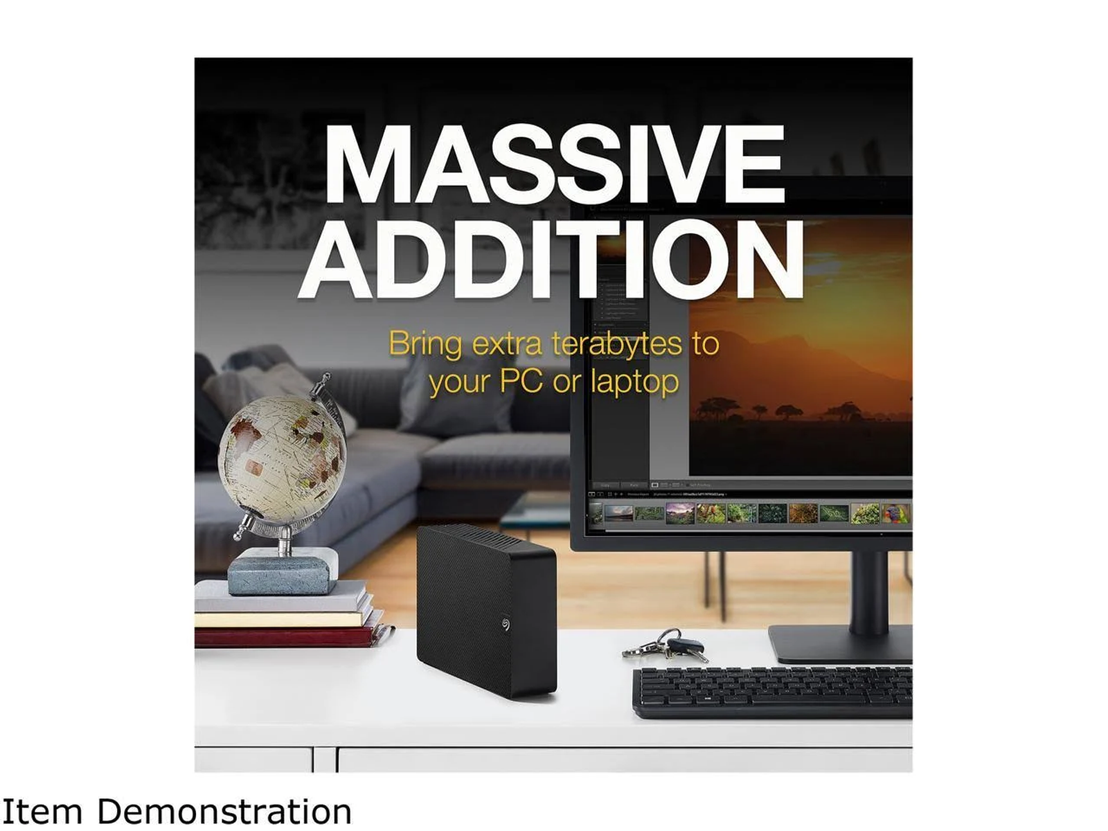 Desktop scene with a monitor, external hard drive, keyboard, and accessories.