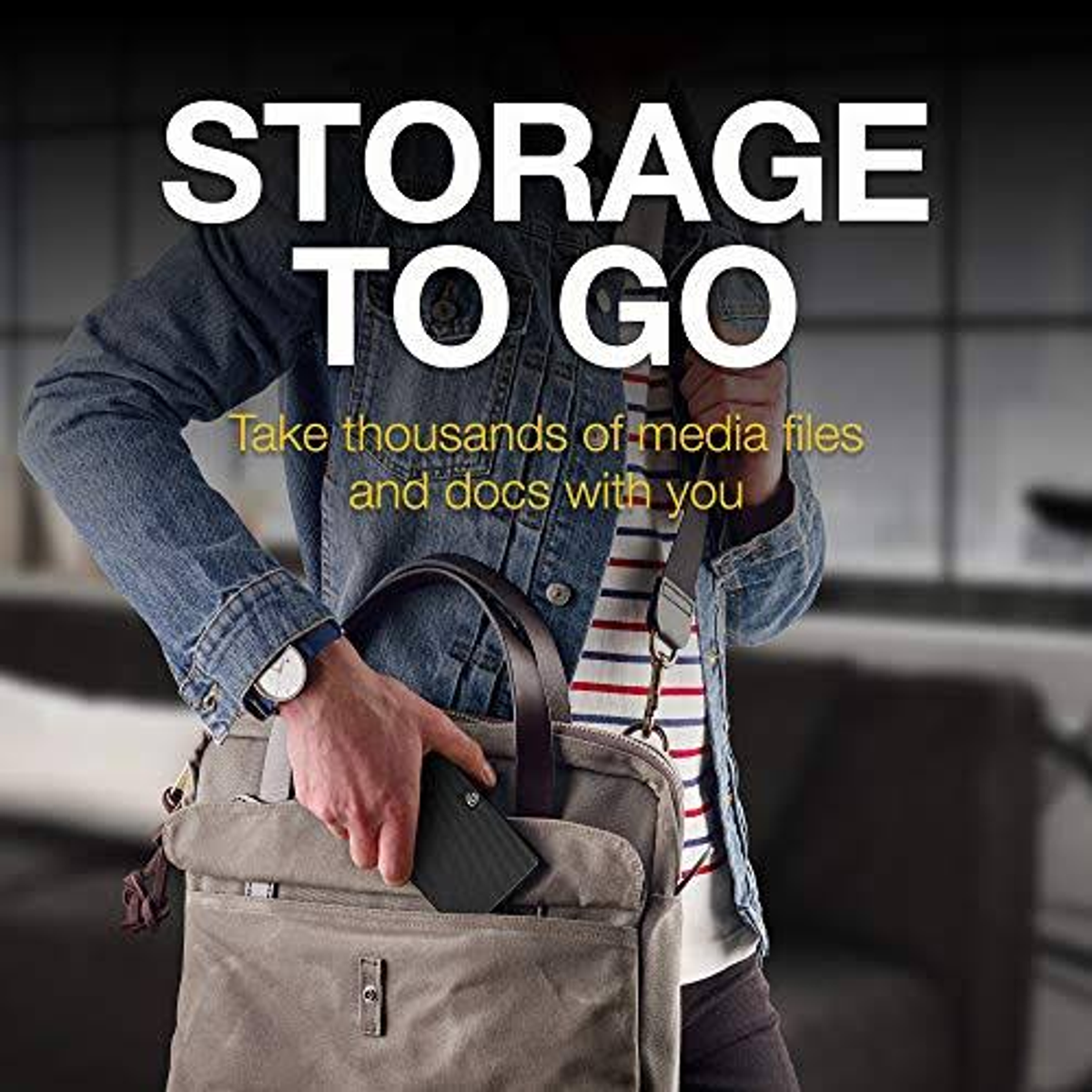 Osoba trzyma szarą torbę z czarnym urządzeniem. Nakładka tekstowa: 'STORAGE TO GO'.