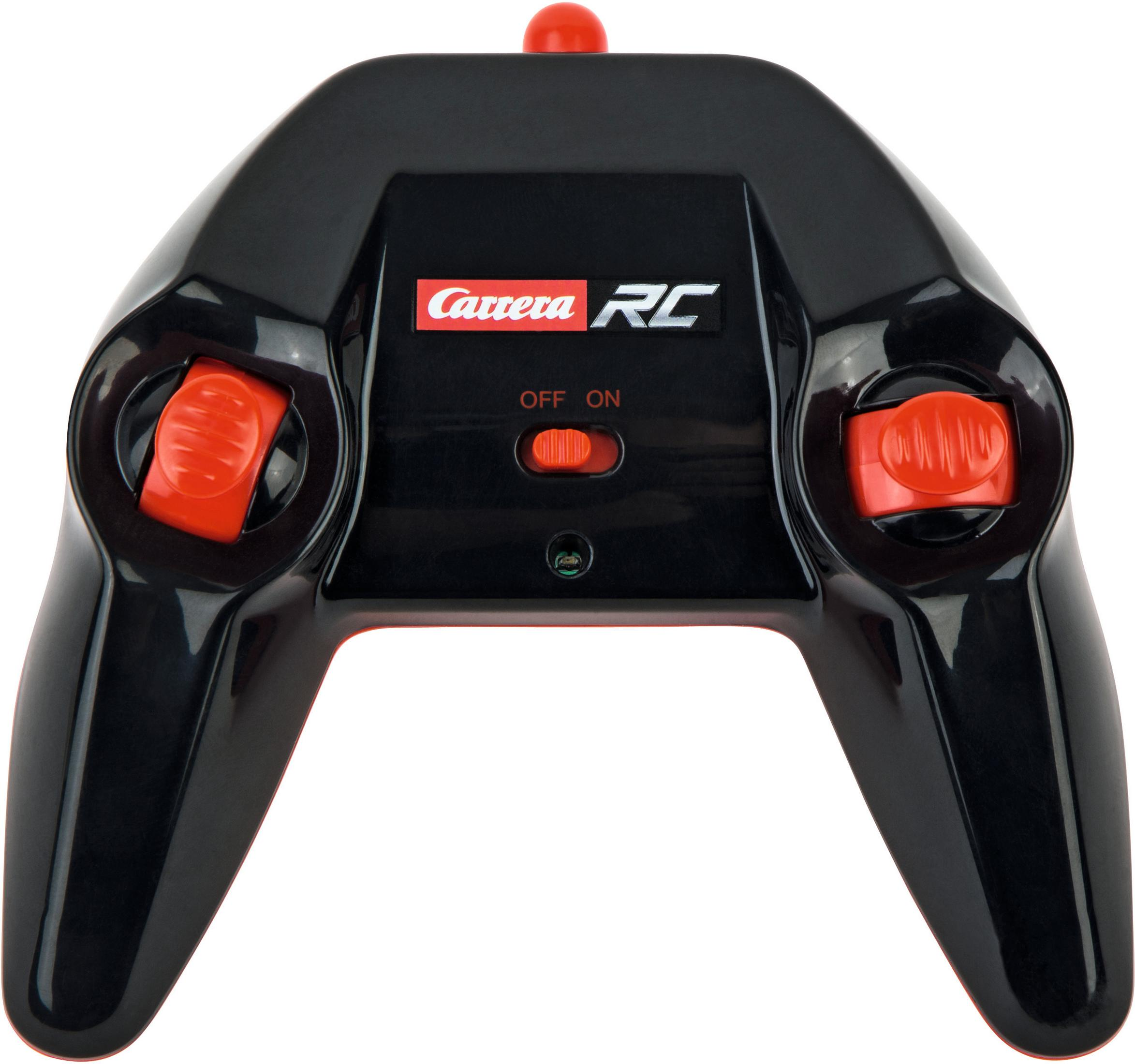 Un mando a distancia Carrera RC negro. Tiene botones rojos y un interruptor de encendido/apagado.
