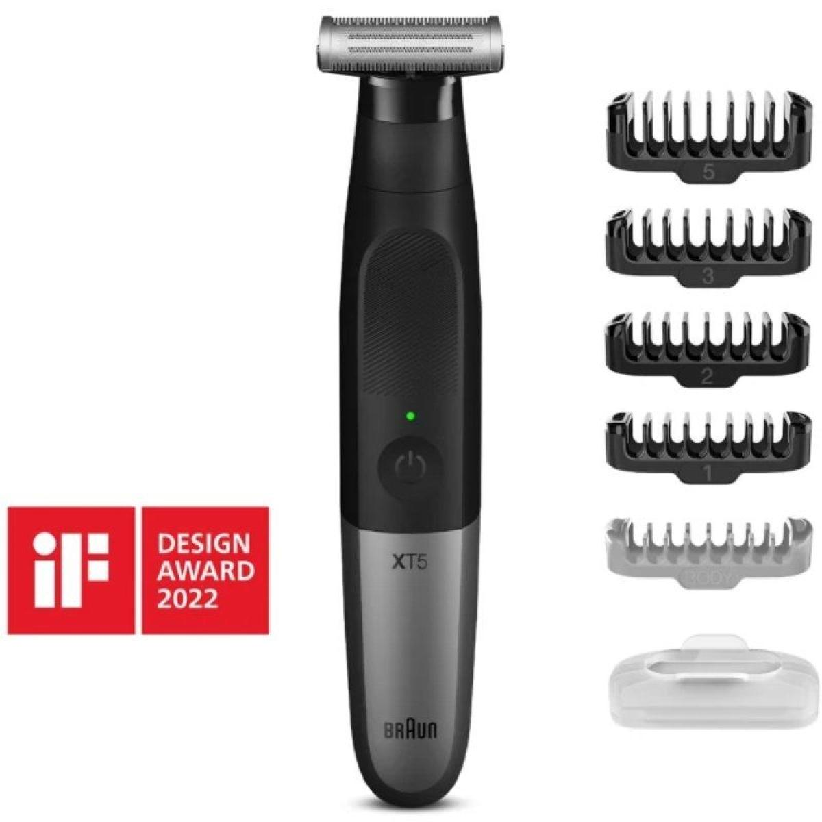 Trimmer nero e argento con accessori. Pulsante di accensione verde. Distintivo premio rosso a sinistra.