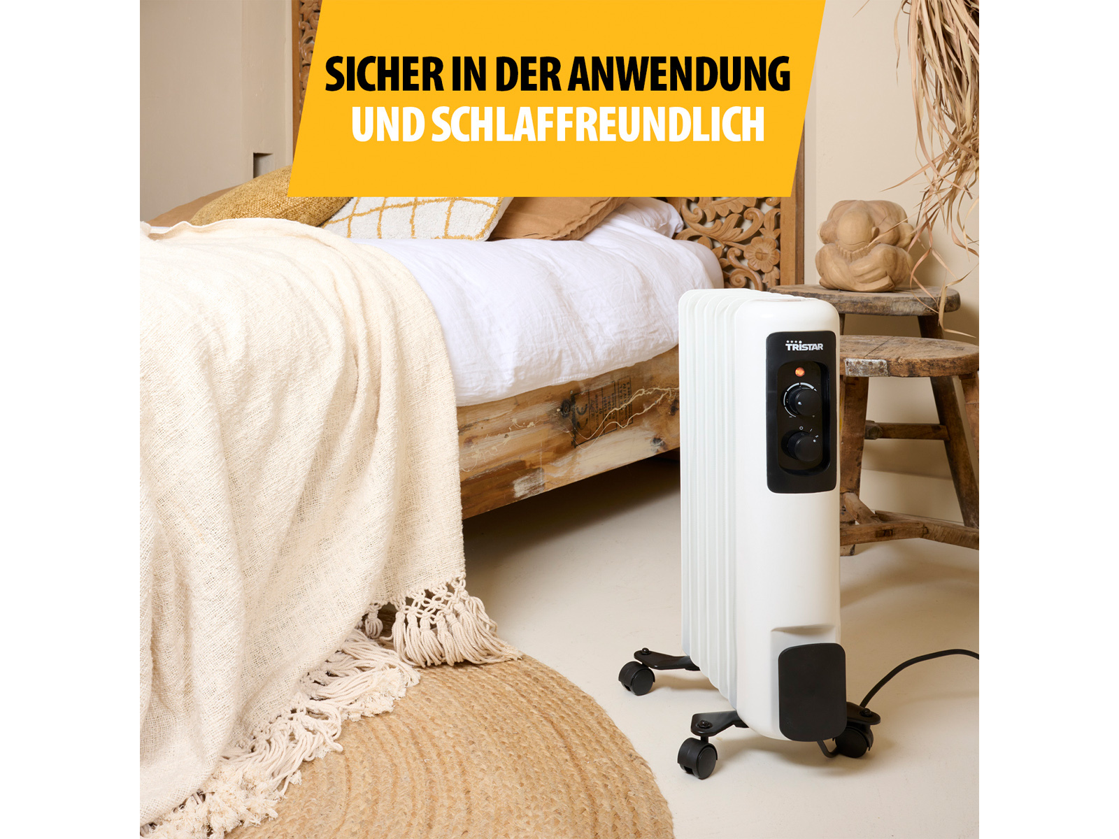 Weißer Tristar-Ölheizkörper auf Rädern in einem Schlafzimmer, mit Textüberlagerung, warme Farben.