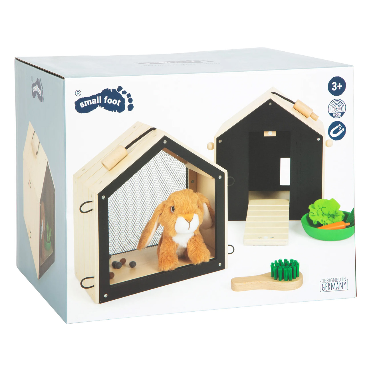 Kiste mit einem Spielzeug-Hasen und einem Holzhaus. Eine grüne Schüssel mit Karotten ist daneben.