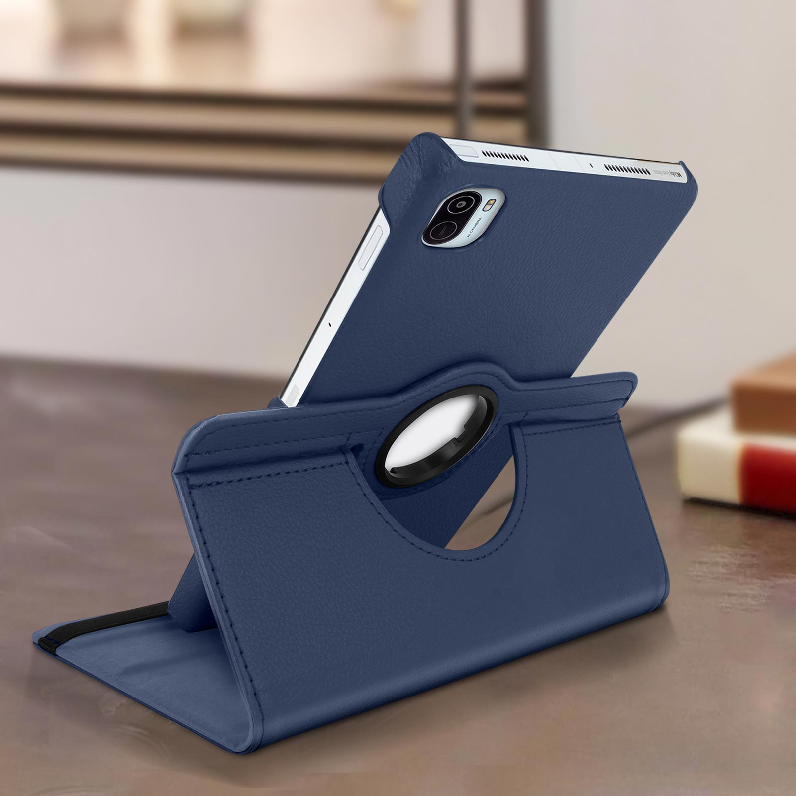 Custodia blu per tablet, angolata su un tavolo. Tablet sulla custodia, superficie blu.
