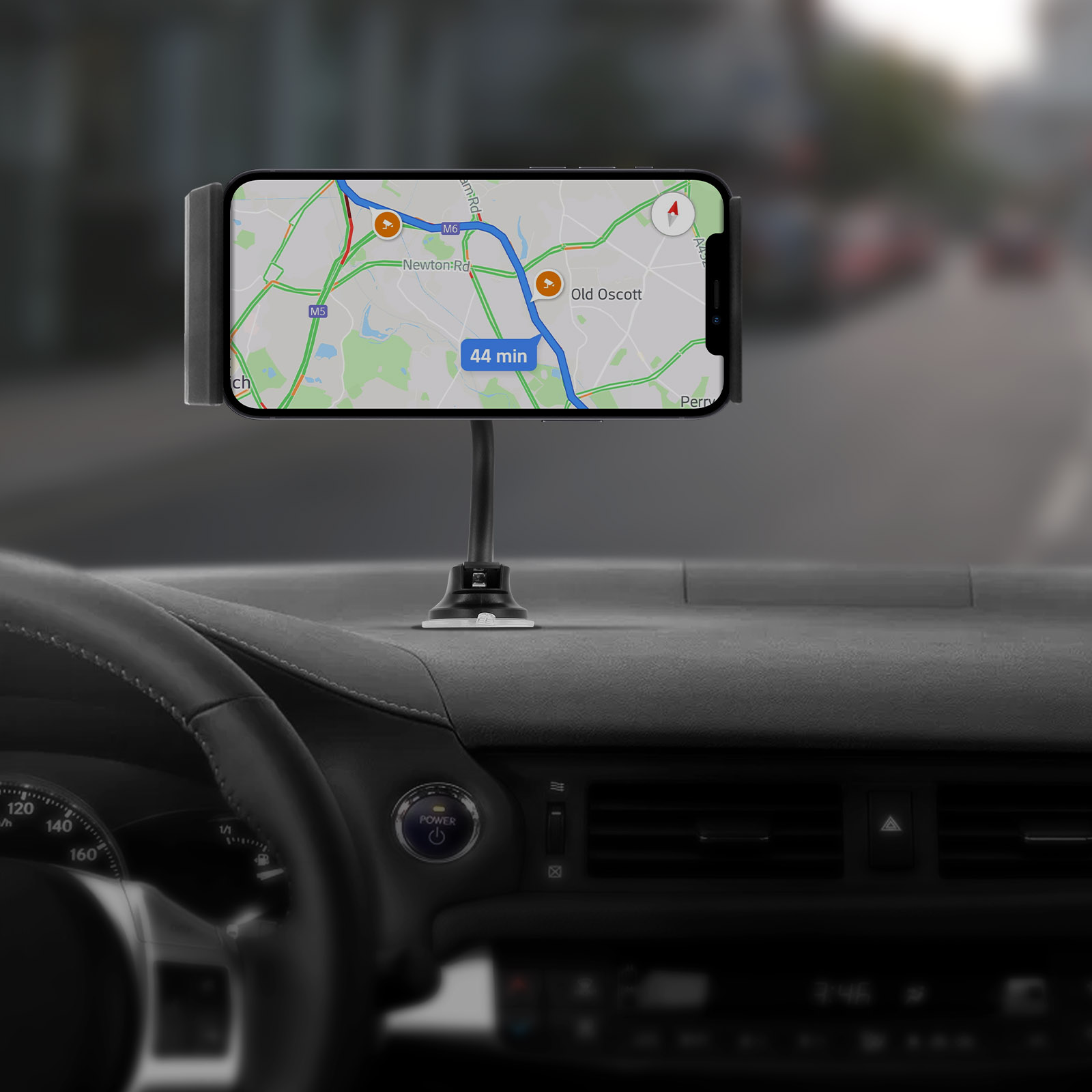 Telefon in Autohalterung mit Karte. Armaturenbrett und Lenkrad im Innenraum sichtbar.