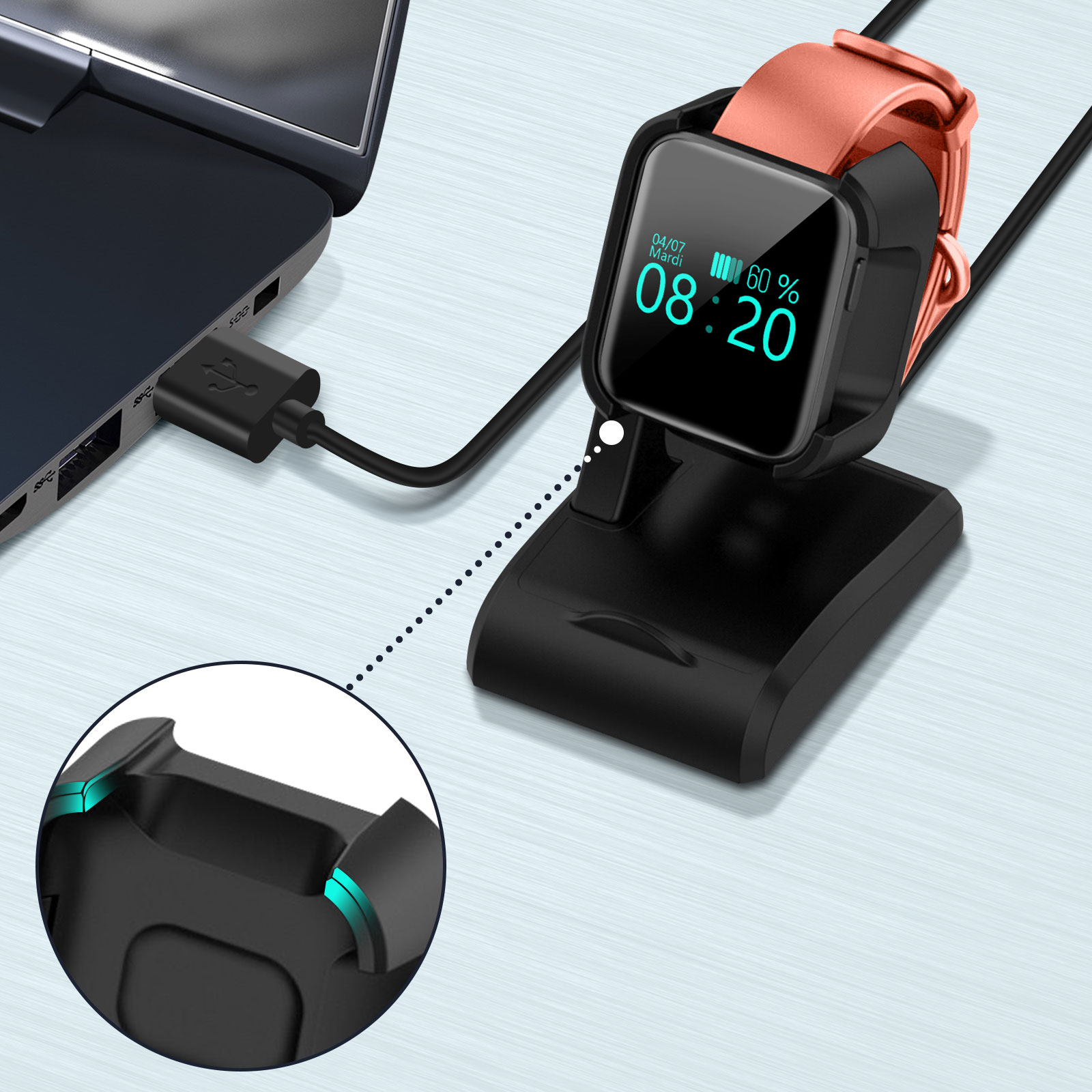 Un reloj inteligente cargándose en una base negra, conectado a una laptop con un cable USB.