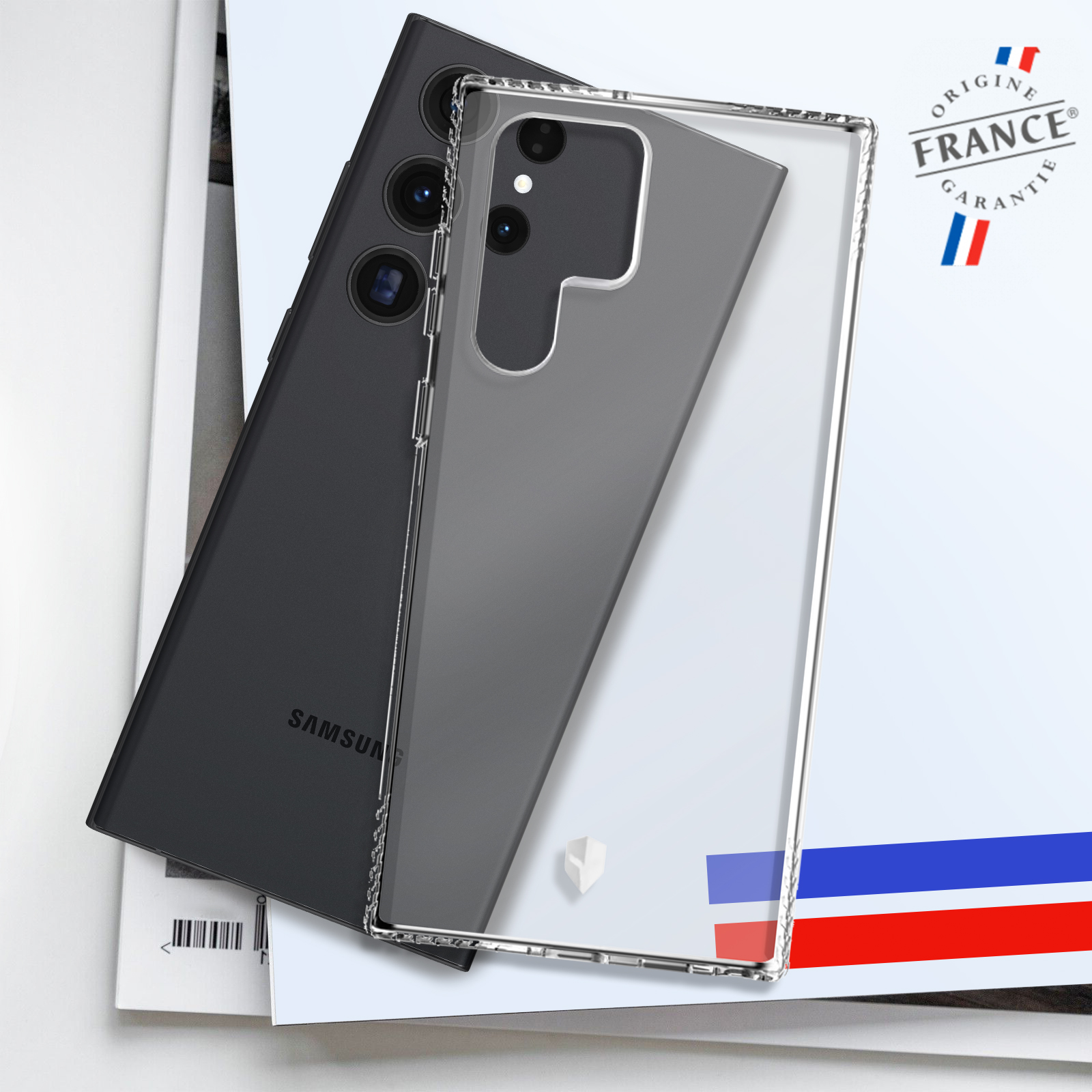 Un téléphone dans une coque transparente sur un magazine, avec drapeau et texte français.