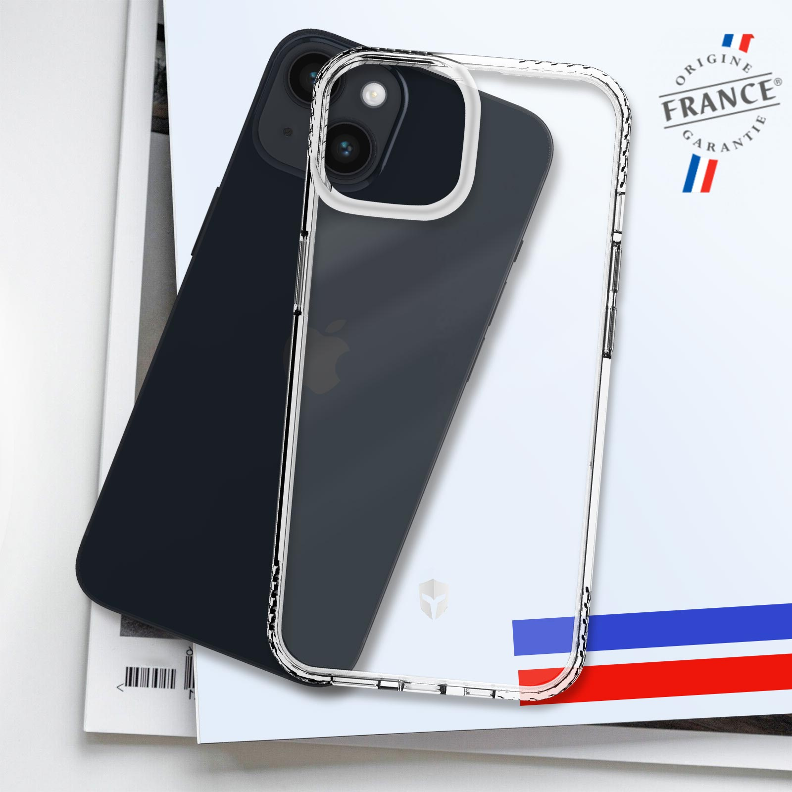 Due telefoni, uno nero e uno con custodia trasparente, su una rivista con bandiera francese.