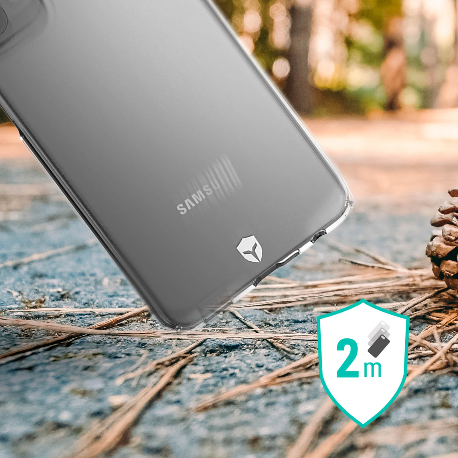 Custodia trasparente per telefono su sfondo sfocato. Il marchio Samsung e un segno di protezione da caduta di 2 m.