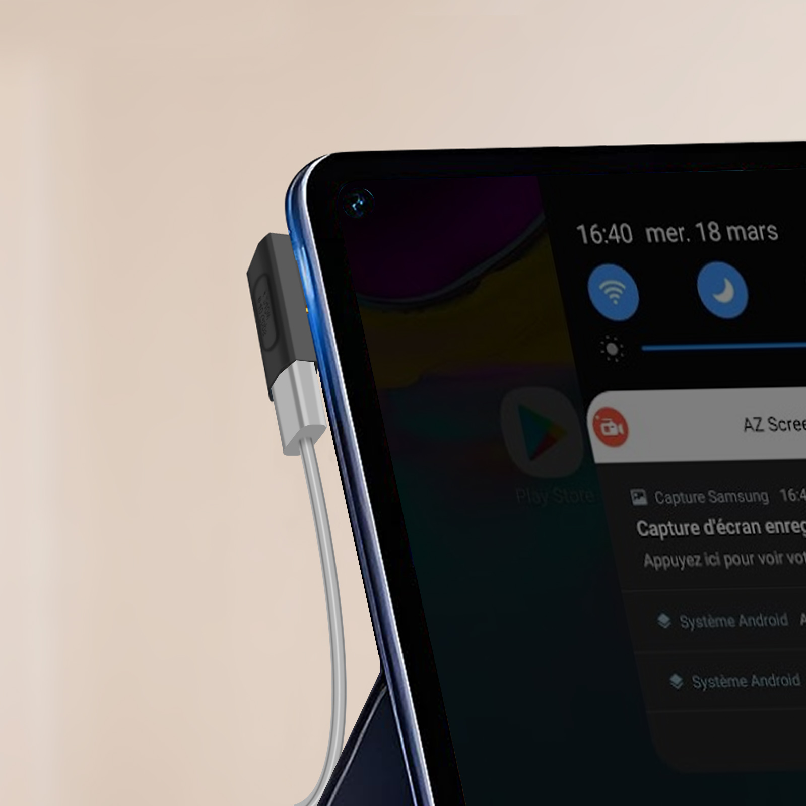 Tablet con connettore collegato, che mostra un'app con notifica. Testo francese visibile.