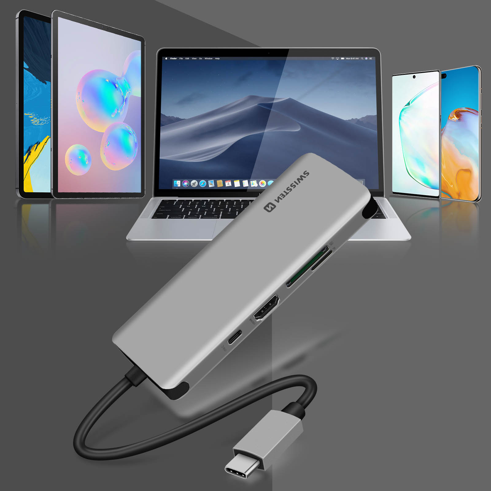 Silberner Hub mit angeschlossenen Geräten. Tablets, Laptop und Telefone. USB-C-Kabel angeschlossen.