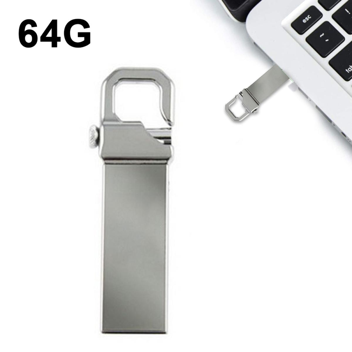 Ein silberner 64G USB-Stick neben einem Laptop mit Tastatur im Blick.