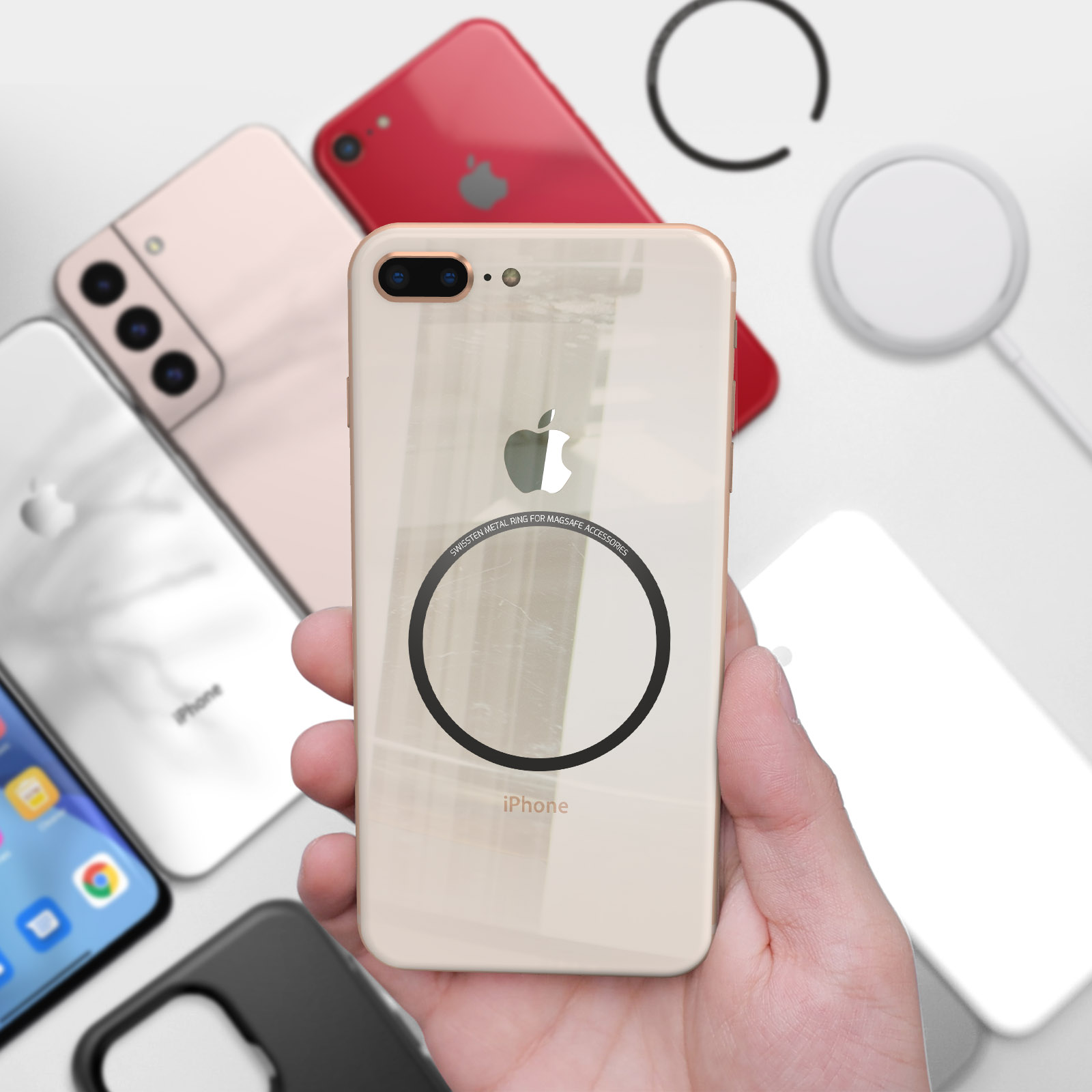 Una mano che tiene un iPhone oro con un anello MagSafe. Altri telefoni sono sullo sfondo.
