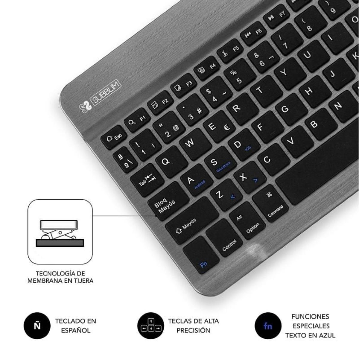 Teclado gris con diseño español y teclas de función. Muestra un mecanismo de tecla de interruptor de tijera.