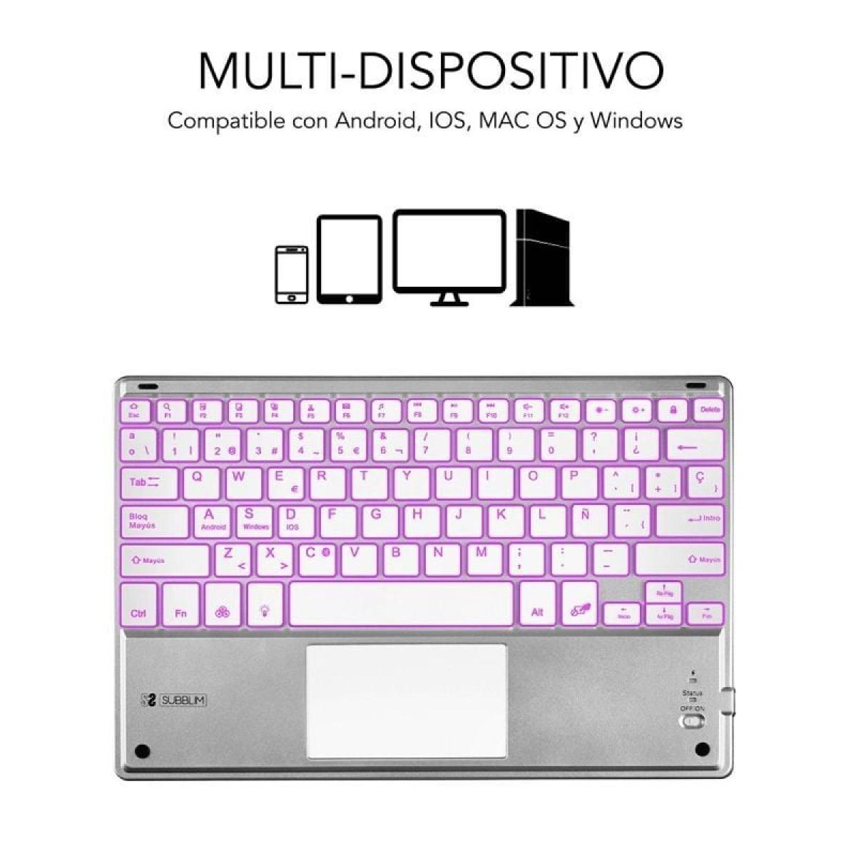 Un teclado inalámbrico con panel táctil. Tiene cuerpo plateado con retroiluminación púrpura.