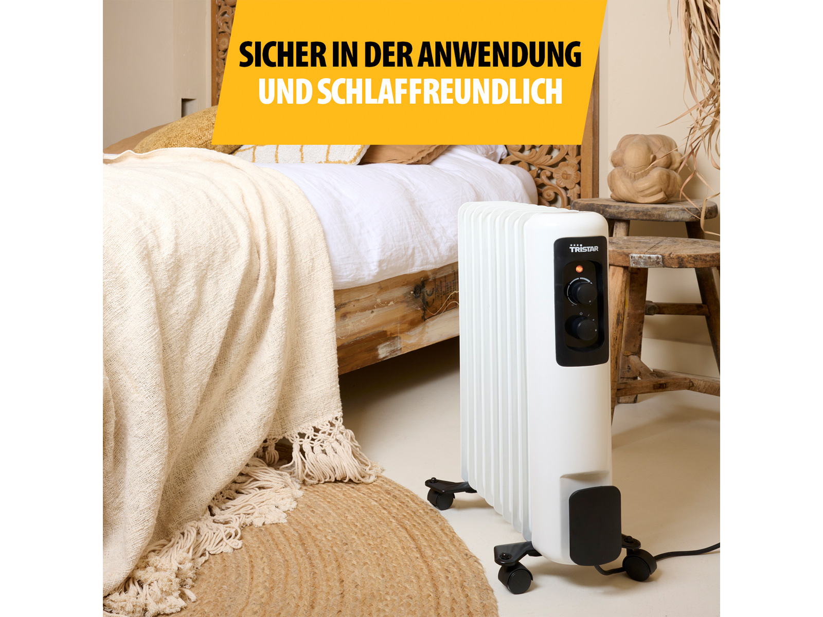 Un radiatore Tristar bianco in una stanza con un letto, un tappeto e una sovrapposizione di testo.
