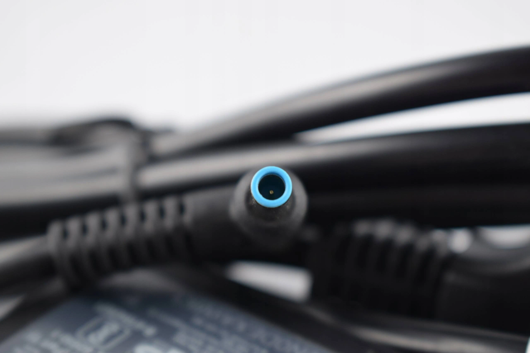 Close-up of a black power supply connector, with a blue inner ring.