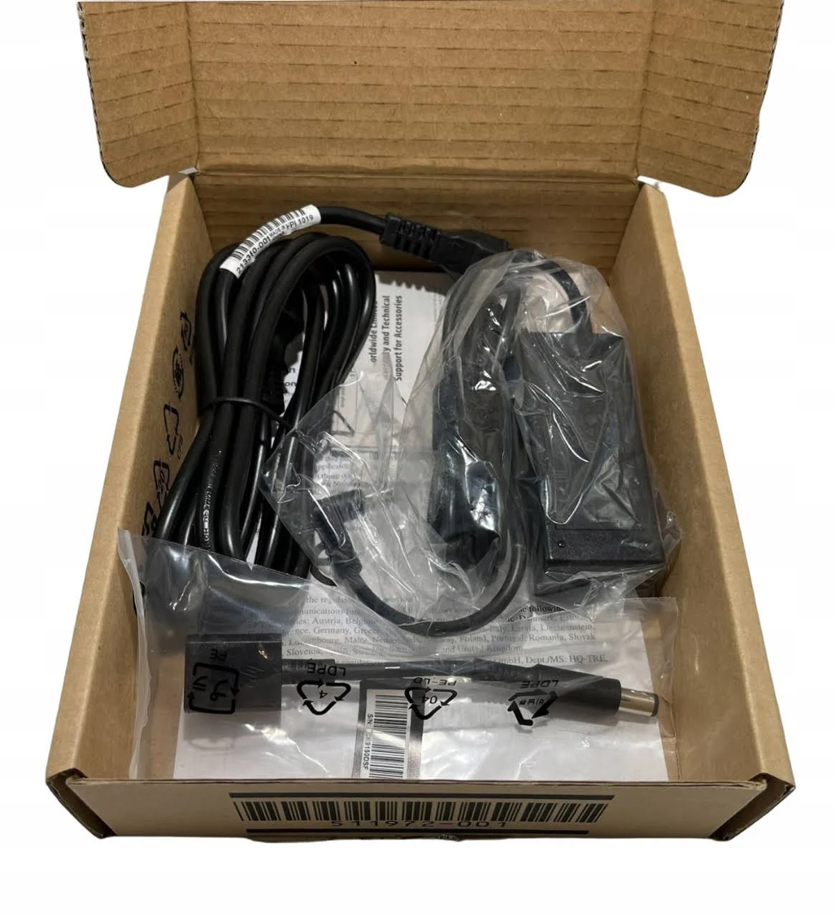 An open cardboard box with cables and accessories inside, packaging for electronics.