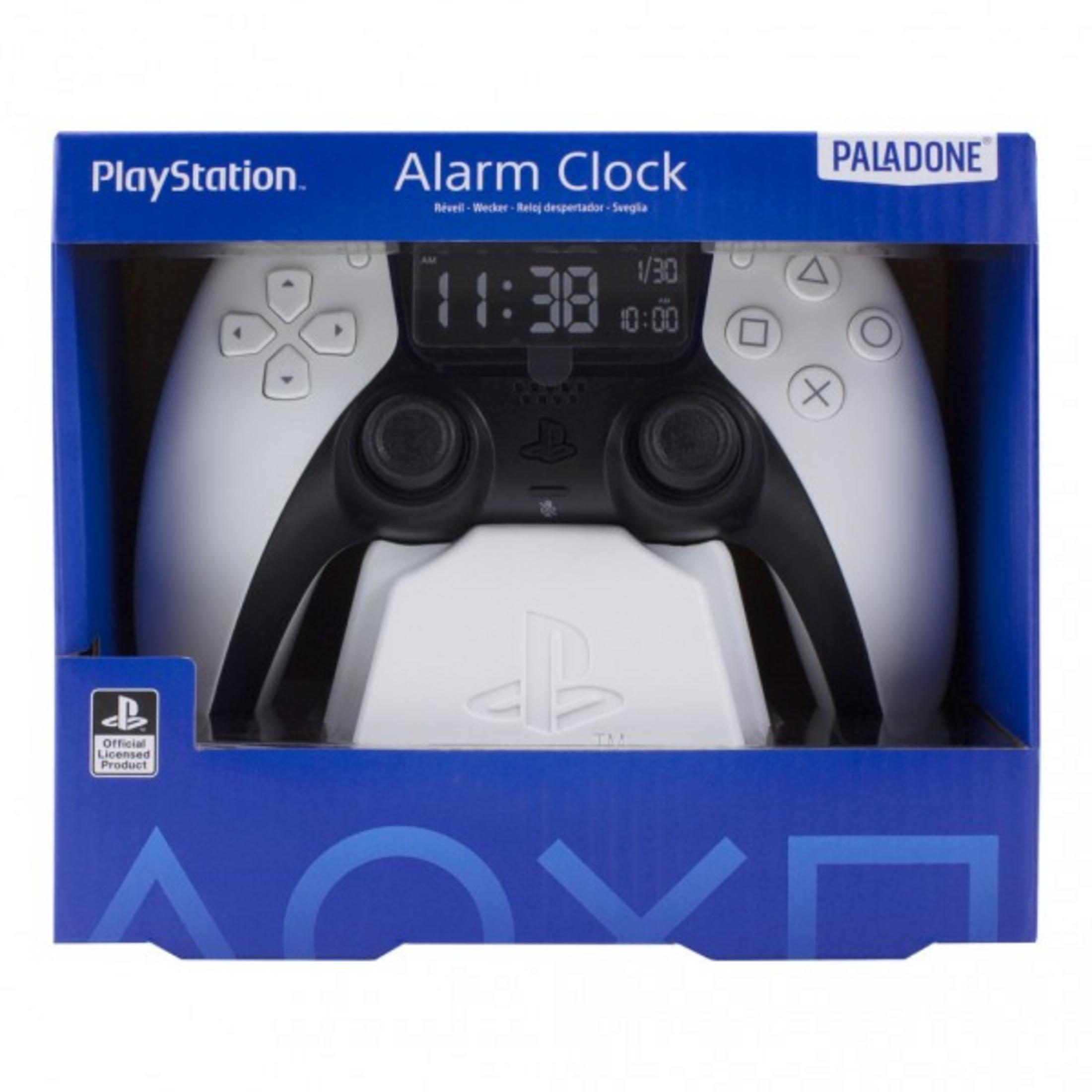 Budzik PlayStation w kształcie kontrolera. Niebieskie pudełko z grafiką kontrolera. Wyświetla godzinę: 11:38 AM.