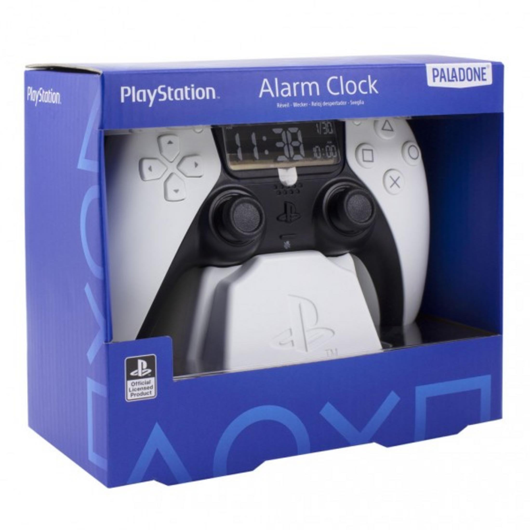Budzik PlayStation w pudełku. Biały kontroler. Niebieskie pudełko z marką PlayStation.