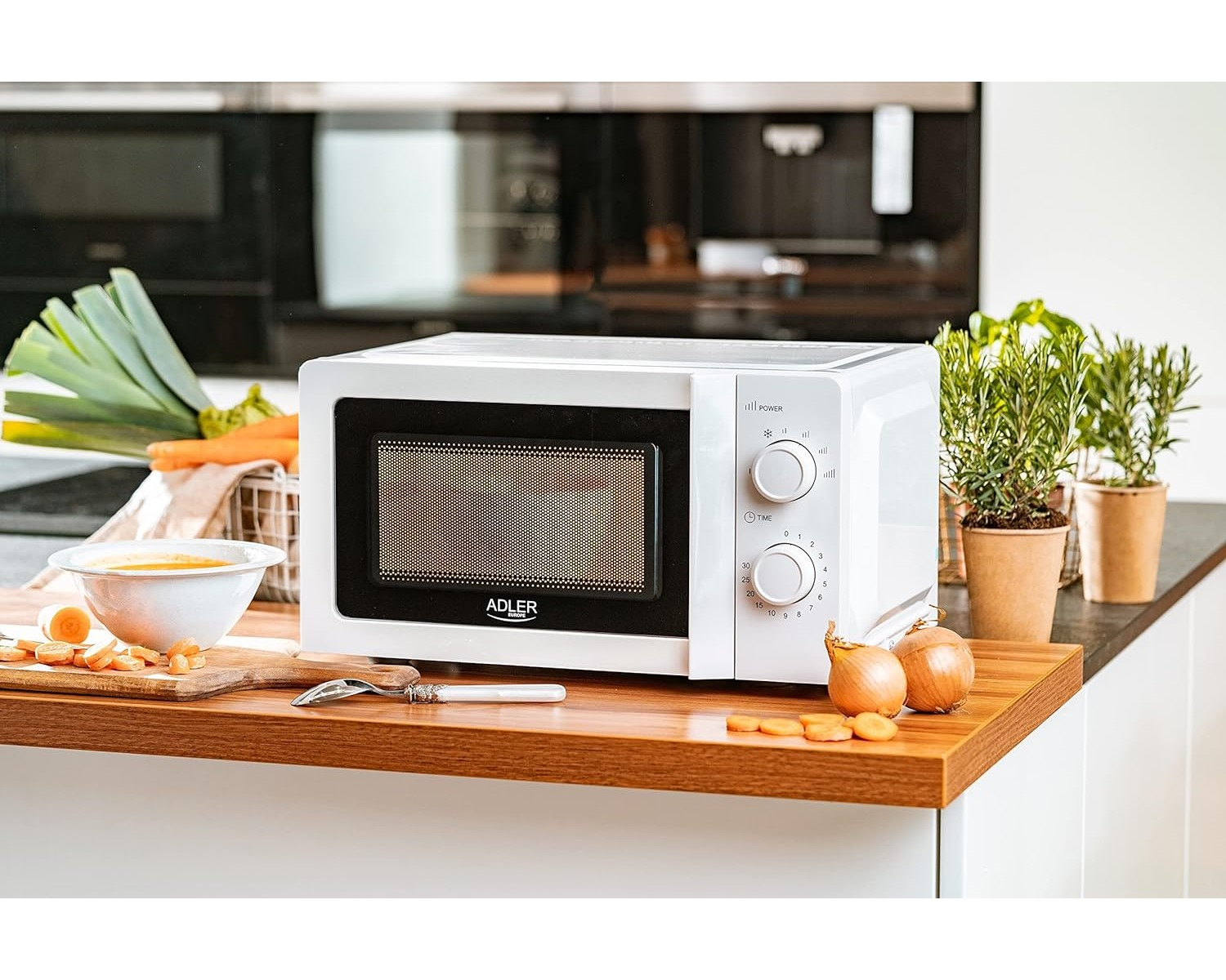 White microwave oven on a wooden countertop. Kitchen background with food.
