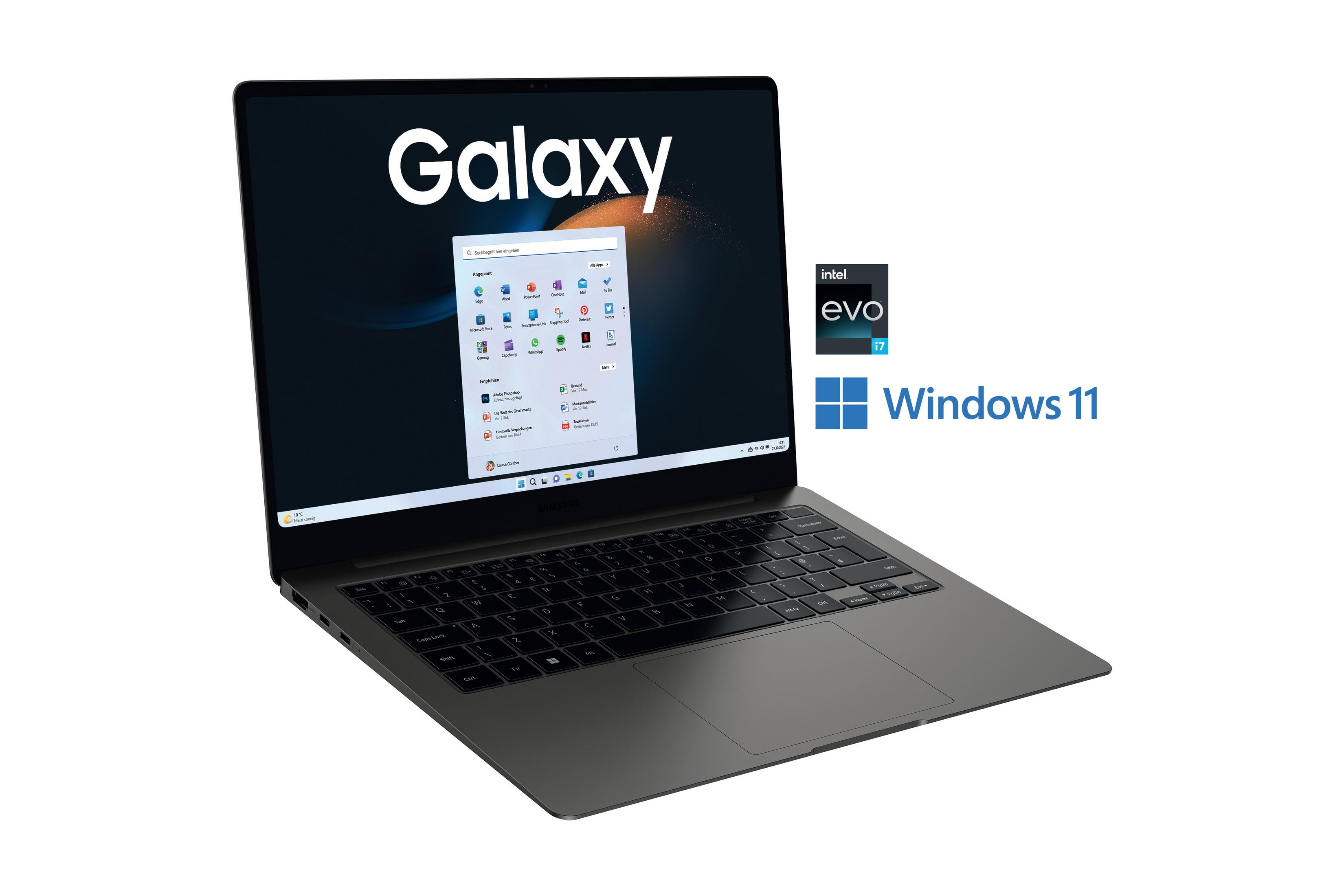 Ein silberner Laptop mit einem Bildschirm, der eine Windows 11-Oberfläche und das Wort Galaxy anzeigt.