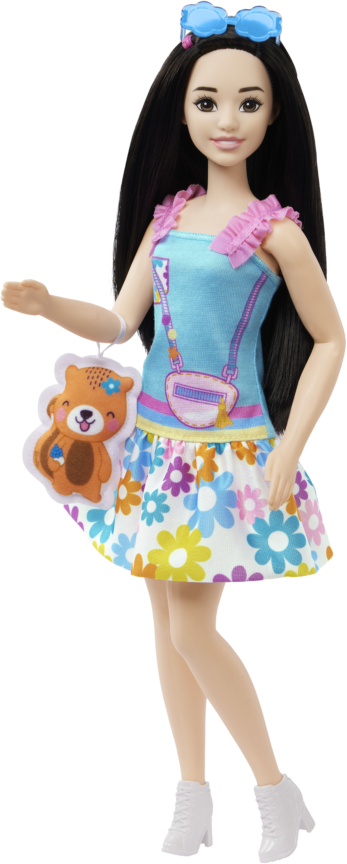 Puppe mit langen schwarzen Haaren und blauem Kleid. Sie hat eine Handtasche und Sonnenbrille.