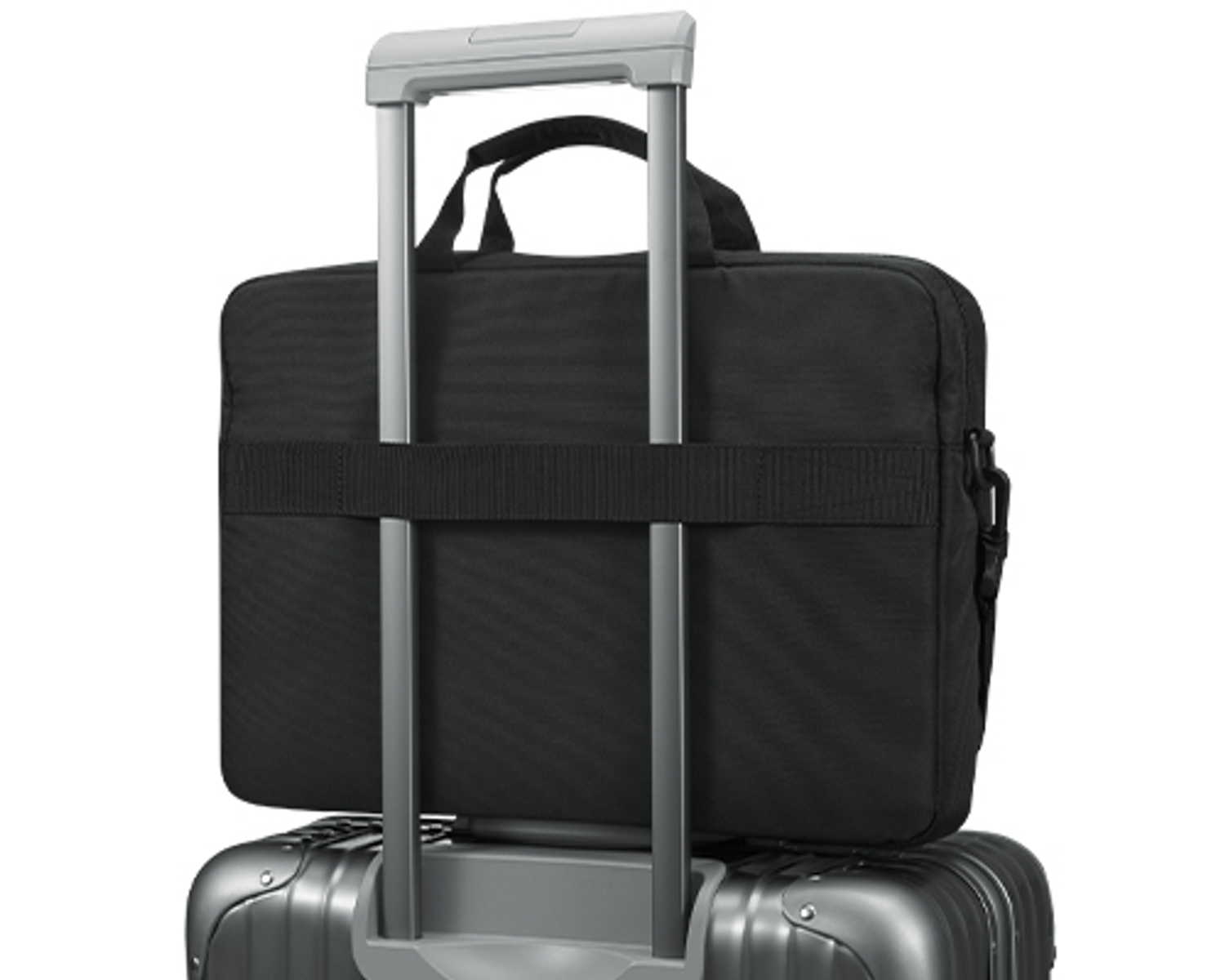 Black laptop bag on top of a silver suitcase. Handle of the suitcase is up.