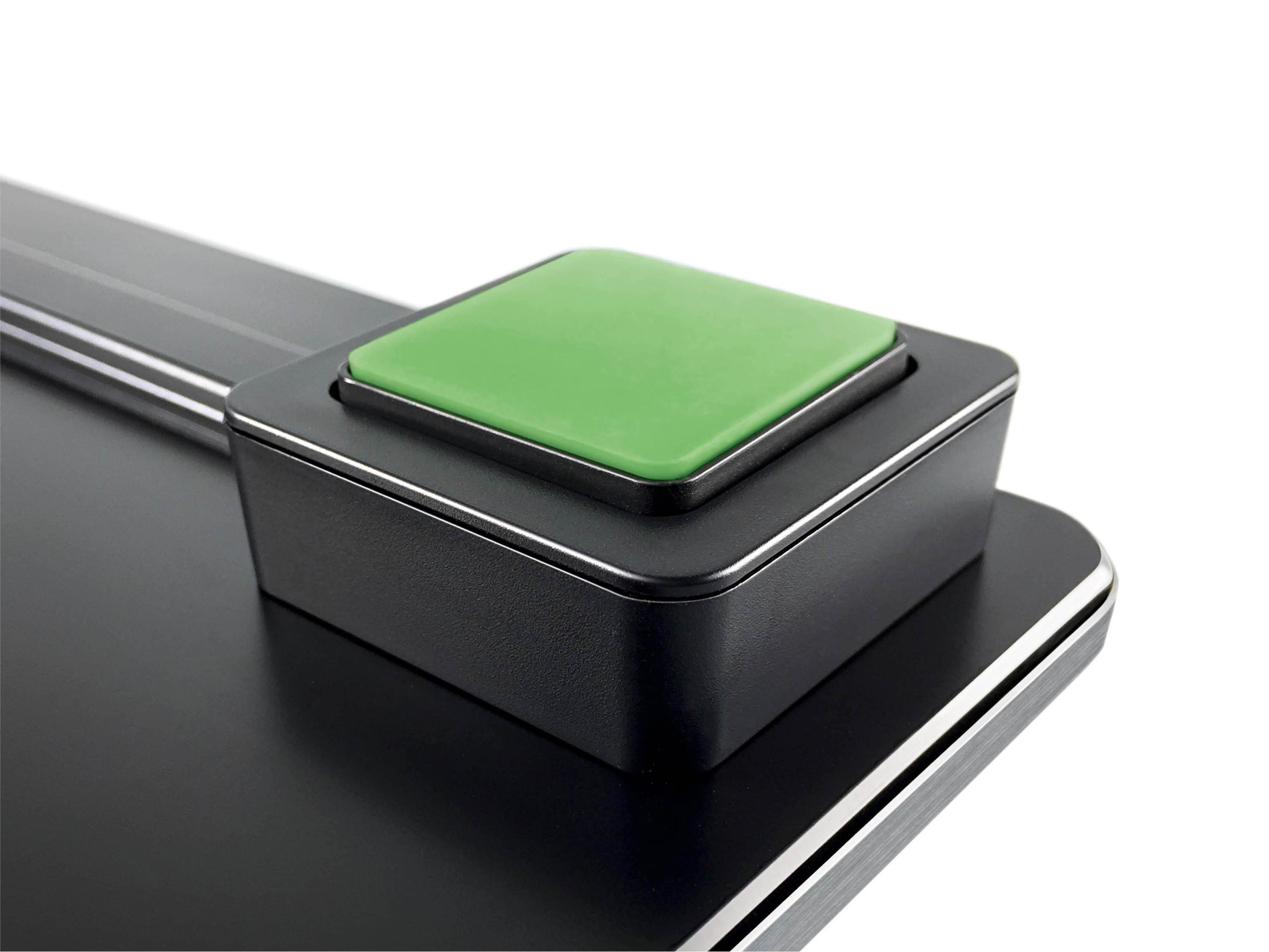 Zbliżenie czarnej wagi z zielonym kwadratowym przyciskiem pośrodku.