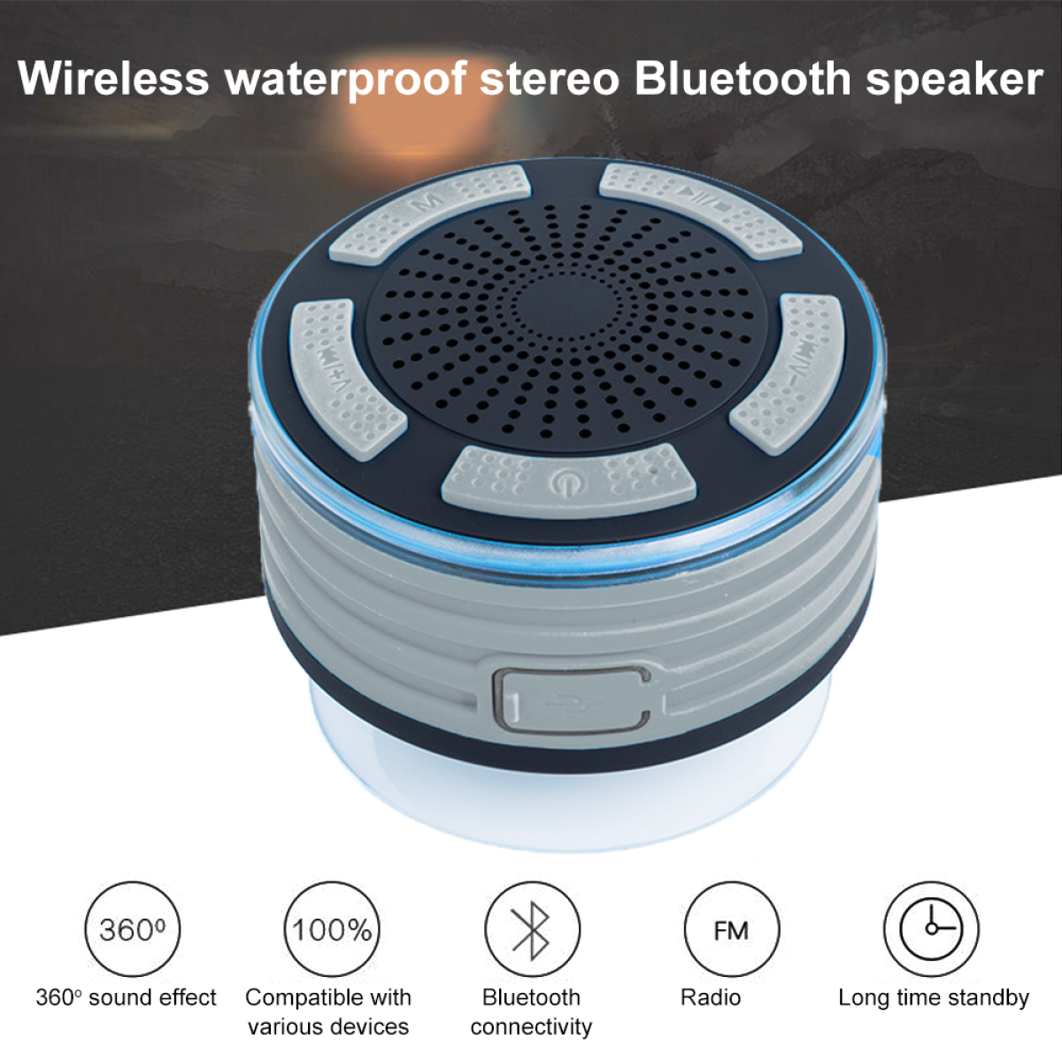 Ein kleiner, runder, grau-schwarzer Bluetooth-Lautsprecher mit Knöpfen und blauem Lichtring.