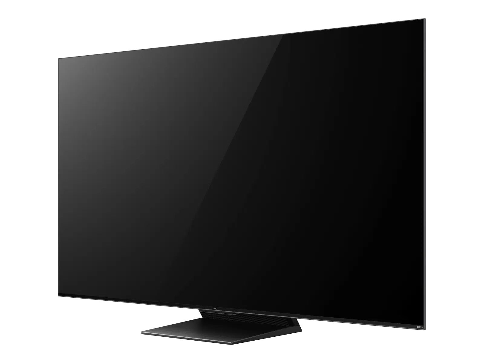 Televisor negro grande sobre un soporte contra un fondo oscuro.