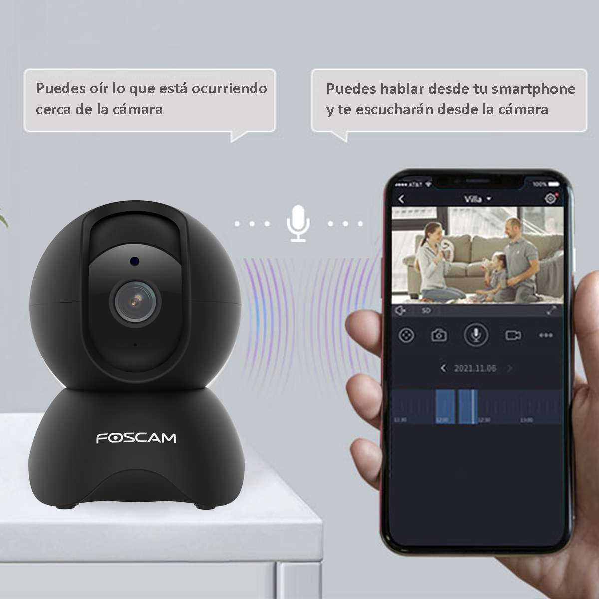 Cámara de seguridad negra sobre una superficie blanca. Un teléfono muestra a una persona en videollamada.