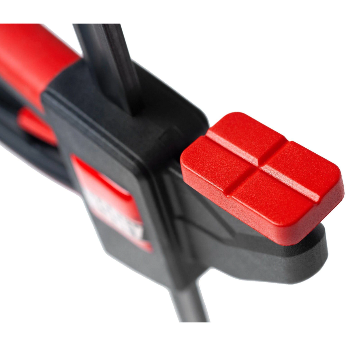 A close-up of a red and black clamp used to hold things together.